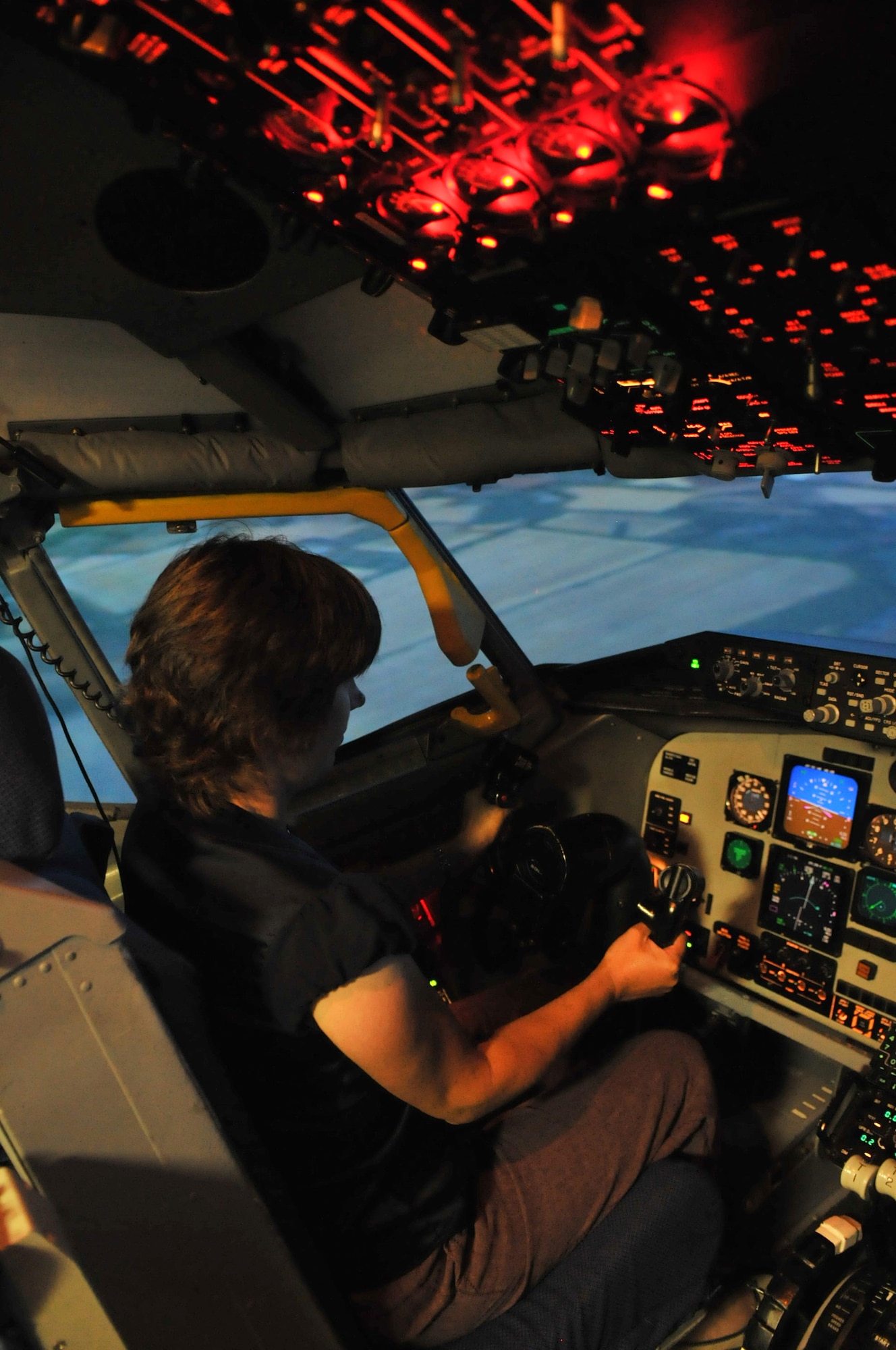 RAF MILDENHALL, England – Anna Batey, school governor at Beck Row Primary School, takes a ride in the KC-135 Stratotanker flight simulator Aug. 21, 2012, in Bldg. 816. The simulator is used as a training tool for pilots to practice flying as well as how to deal with scenarios such as in-flight emergencies and flying in varying weather conditions. (U.S. Air Force photo/Senior Airman Jerilyn Quintanilla) 