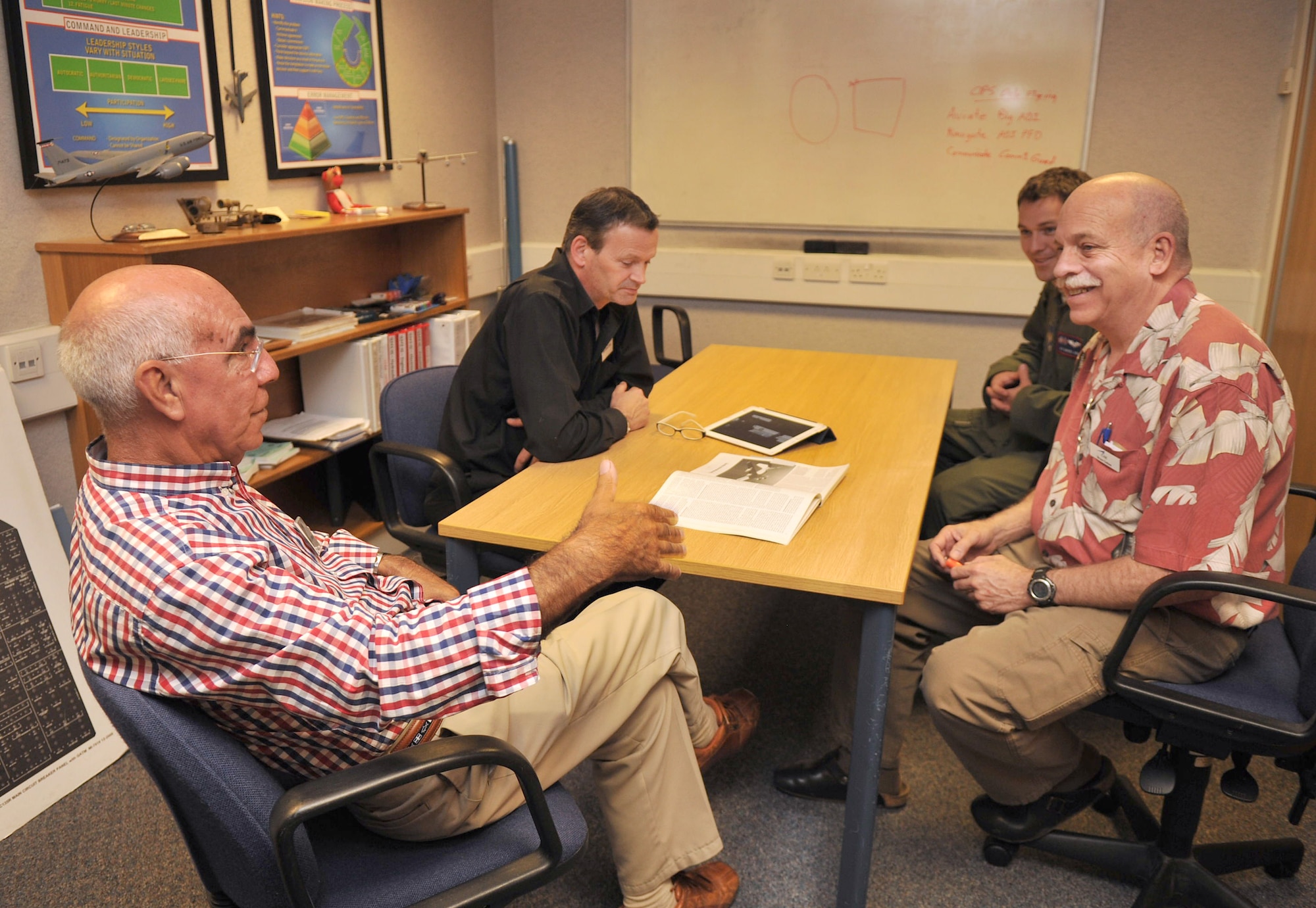 RAF MILDENHALL, England – From left, Ken Thompson, British-American Committee member, David Hines, local business owner, Airman 1st Class Gabriel King, 351st Air Refueling Squadron, and Bruce Golson, base contractor, speak about the KC-135 Stratotanker flight simulator Aug. 21, 2012, in Bldg. 816. Members of the local community and the British-American Committee toured several base facilities including the air traffic control tower, fire department, flight simulator and a static aircraft on the flightline. They also received a wing mission brief and saw a 100th Security Force’s Military Working Dog demonstration. (U.S. Air Force photo/Senior Airman Jerilyn Quintanilla)  
