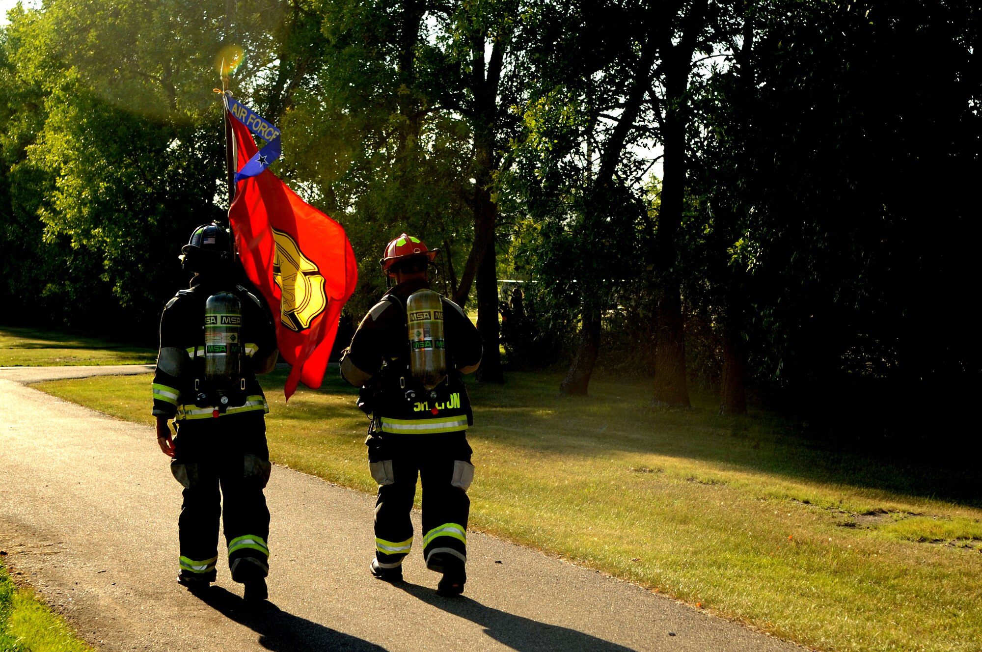 Tech. Sgt. Byron Ball and Airman 1st Class Alec Ribbink, 319th Civil Engineer Squadron, begin a “Run for the Fallen” 5K event in full firefighting gear on Grand Forks Air Force Base N.D., Aug. 17, 2012. More than 60 participants covered a total of 198.4 miles in support of fallen service members from Operations Iraqi Freedom and Enduring Freedom. (U.S. Air Force photo/ Staff Sgt. Amanda Grabiec)