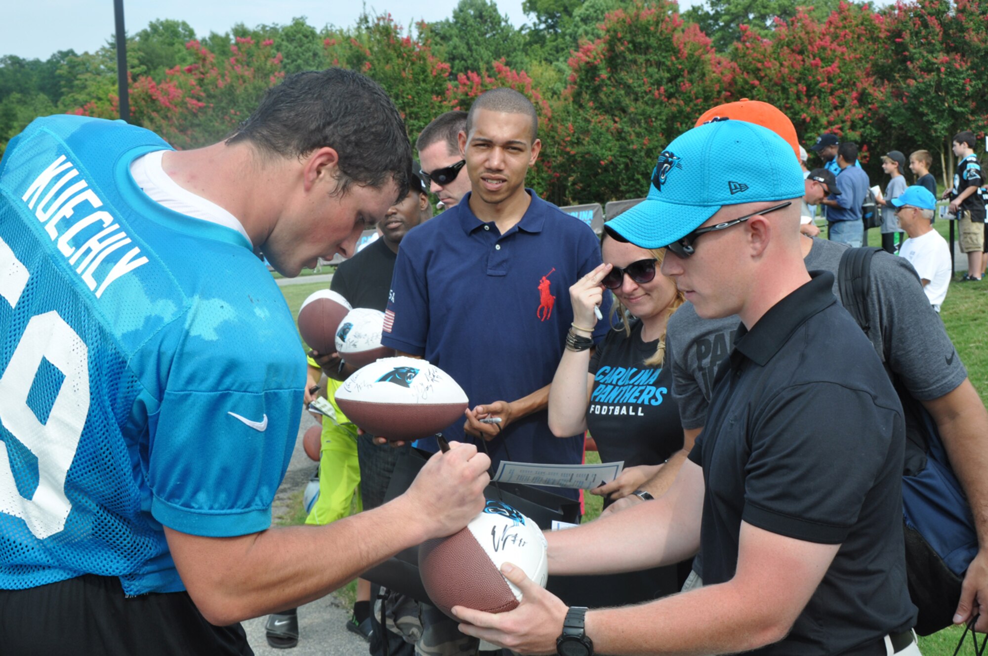 Senior Airmen Michael Redd, 916th Security Forces, has a ball signed by Carolina Panthers player Luke Kuechly on Aug. 10, 2012. Kuechly was a number one draft pick for the NFL this season. (USAF photo by Maj. Shannon Mann, 916ARW/PA)