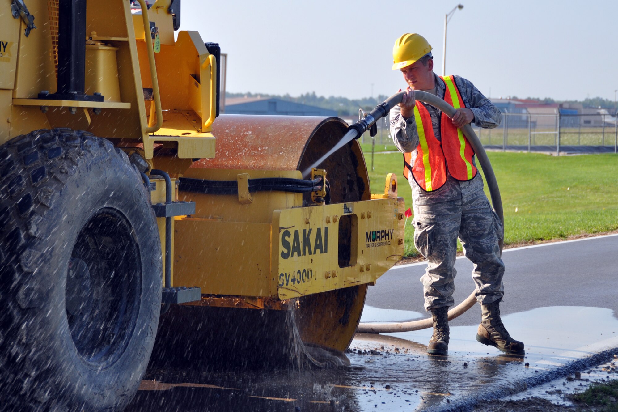 Senior Airman Bradley Morgan, a knowledge management specialist assigned to the 307th Civil Engineer Squadron from Barksdale Air Force Base, La., cleans a piece of heavy equipment at Youngstown Air Reserve Station, Vienna, Ohio, Aug. 16, 2012. Morgan was part of a 29-person detail from Barksdale that spent two weeks at Youngstown assisting the 910 CES build a Prime Base Engineer Emergency Force (Prime BEEF) training area. (U.S. Air Force photo by Master Sgt. Jeff Walston) 