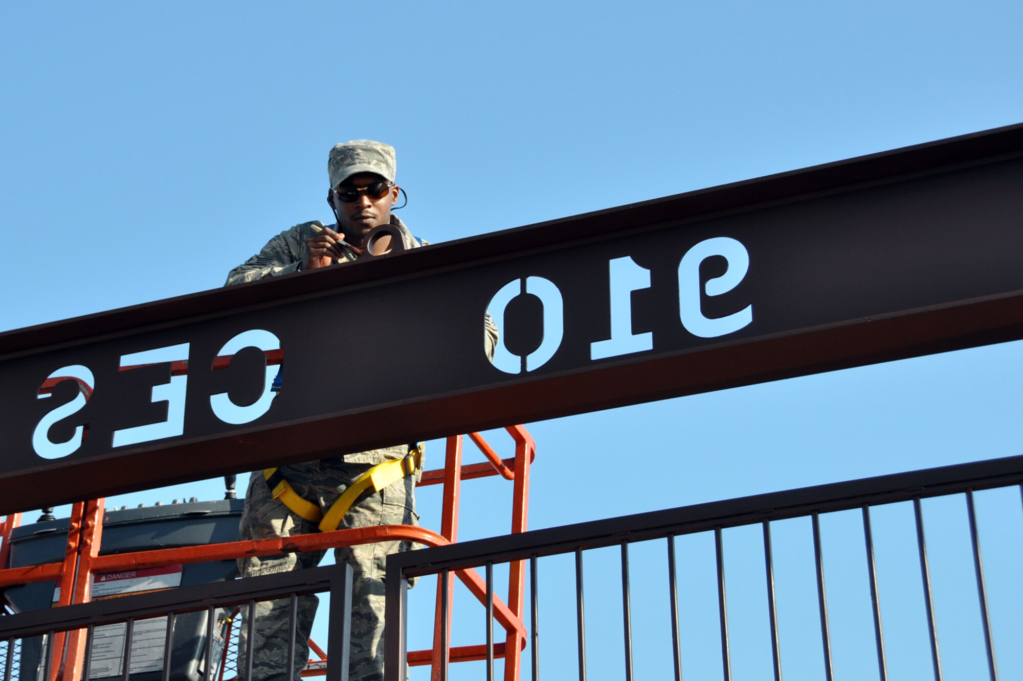 Senior Airman Hubert Staten, a heating, ventilation, air conditioning and refrigeration technician, assigned to the 307th Civil Engineer Squadron from Barksdale Air Force Base, La., paints a gate at the Youngstown Air Reserve Station, Vienna, Ohio, Aug. 16, 2012. Staten was part of a 29-person detail from Barksdale Air Force Base, La., that spent two weeks at Youngstown assisting the 910 Civil Engineer Squadron build a Prime Base Engineer Emergency Force (Prime BEEF) training area. (U.S. Air Force photo by Master Sgt. Jeff Walston)