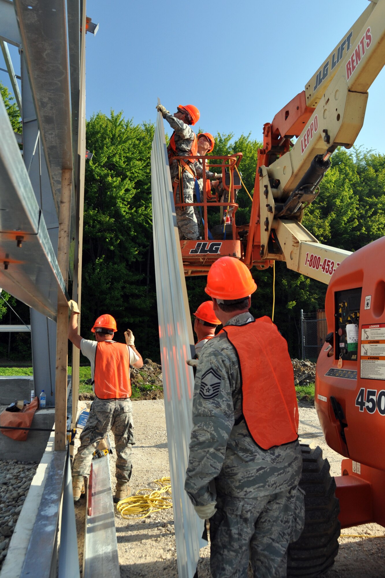 Members of the 307th Civil Engineer Squadron from Barksdale Air Force Base, La., join 910th Civil Engineer Squadron personnel in the construction of a Pre-Engineered building, at Youngstown Air Reserve Station, Vienna, Ohio, Aug. 5, 2012. A 29-person detail from Barksdale spent two weeks at Youngstown assisting the 910 CES build a Prime Base Engineer Emergency Force (Prime BEEF) training area. (U.S. Air Force photo by Master Sgt. Jeff Walston) 