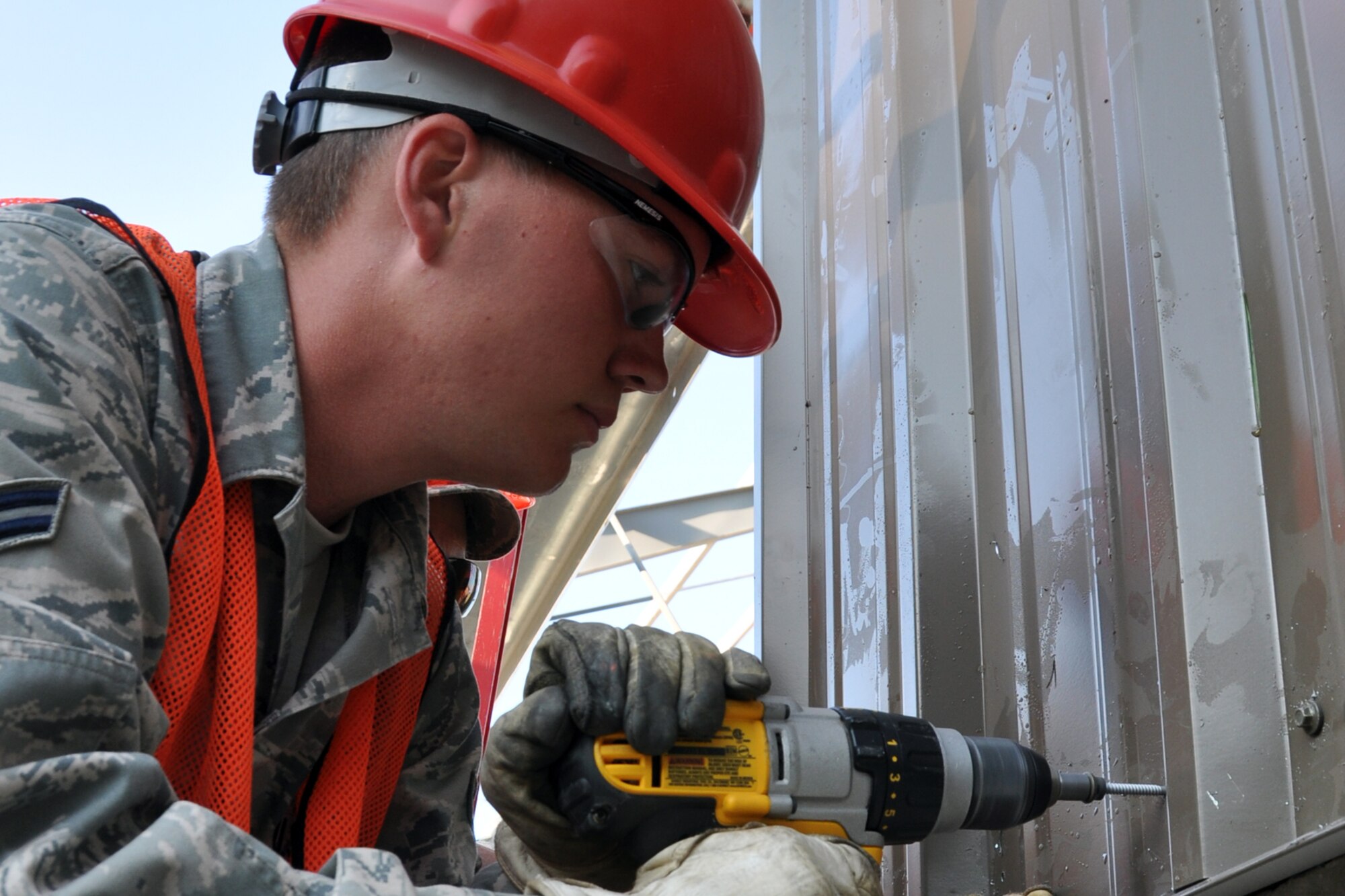 Airman 1st Class Zachary Chaney, an electrician assigned to the 307th Civil Engineer Squadron from Barksdale Air Force Base, La., screws a sheet of metal into place during the construction of a Pre-Engineered building at Youngstown Air Reserve Station, Vienna, Ohio, Aug. 16, 2012. He was part of a 29-person detail from Barksdale that spent two weeks at Youngstown ARS assisting 910th Civil Engineer Squadron personnel build a Prime Base Engineer Emergency Force (Prime BEEF) training area. (U.S. Air Force photo by Master Sgt. Jeff Walston)