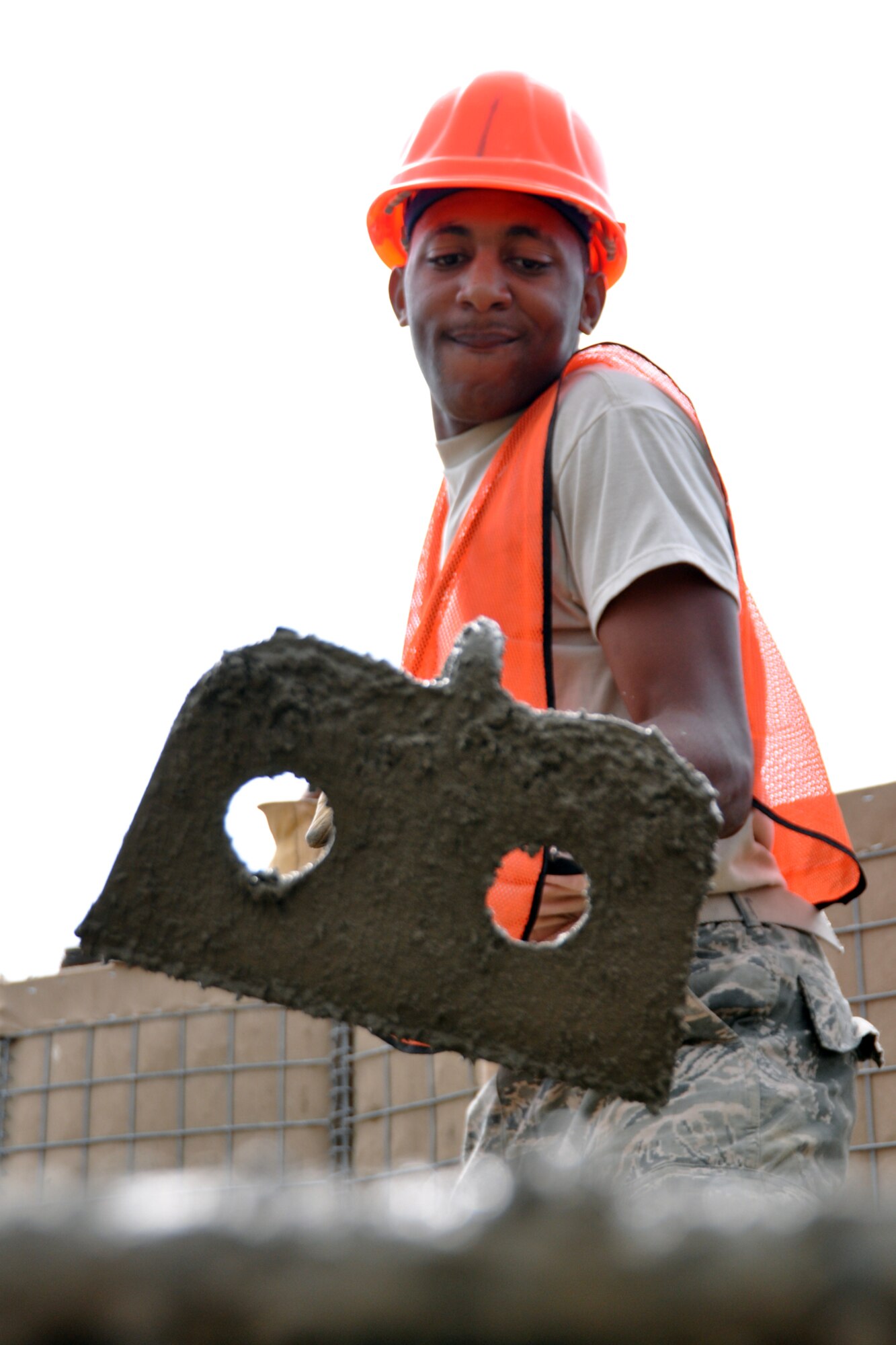 Senior Airman Caleb Williams, a power production engineer assigned to the 307th Civil Engineer Squadron at Barksdale Air Force Base, La., mixes cement by hand at Youngstown Air Reserve Station, Vienna, Ohio, Aug. 14, 2012. Williams was part of a 29-person detail from Barksdale that spent two weeks at Youngstown assisting the 910 Civil Engineer Squadron build a Prime Base Engineer Emergency Force (Prime BEEF) training area. (U.S. Air Force photo by Master Sgt. Jeff Walston) 