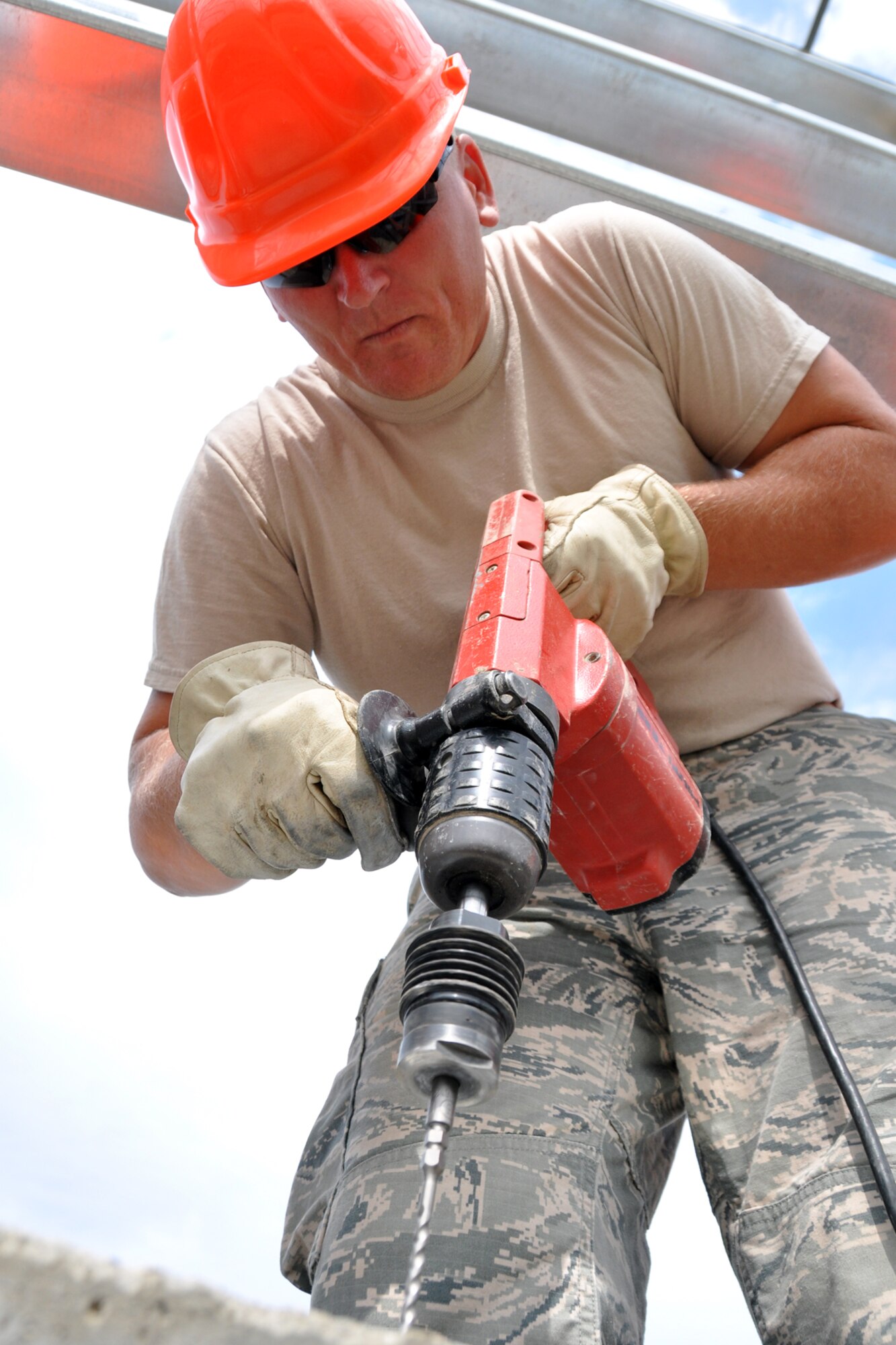 Tech. Sgt. Billy Smith, shop lead for power production at the 307th Civil Engineer Squadron, Barksdale Air Force Base, La., drills holes into a cement structure at Youngstown Air Reserve Station, Vienna, Ohio, Aug. 14, 2012. Morgan was part of a 29-person detail from Barksdale that spent two weeks at Youngstown assisting the 910th Civil Engineer Squadron build a Prime Base Engineer Emergency Force (Prime BEEF) training area. (U.S. Air Force photo by Master Sgt. Jeff Walston) 