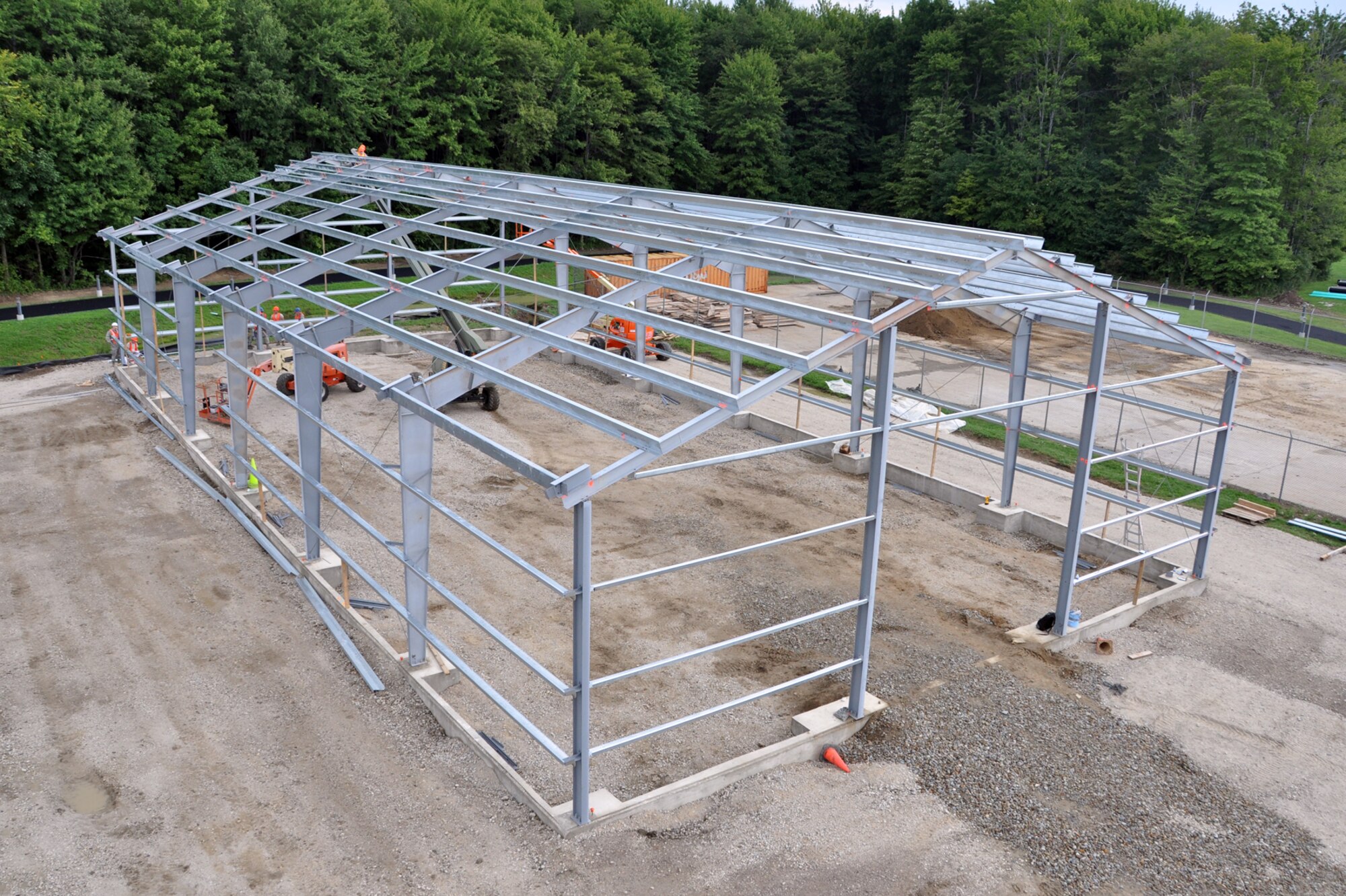 Members of the 307th Civil Engineer Squadron from Barksdale Air Force Base, La., join 910th Civil Engineer Squadron personnel in the construction of a Pre-Engineered building, at Youngstown Air Reserve Station, Vienna, Ohio, Aug. 14, 2012. A 29-person detail from Barksdale spent two weeks at Youngstown assisting the 910 CES build a Prime Base Engineer Emergency Force (Prime BEEF) training area. (U.S. Air Force photo by Master Sgt. Jeff Walston) 