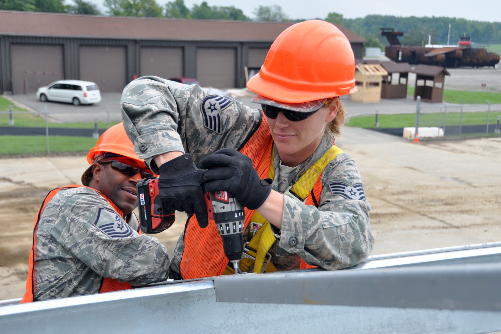Master Sgt. Alfred Cain, a heating, ventilation, air conditioning and refrigeration technician, holds a support spacer in place as Staff Sgt. Angel Hirschi, a utilities journeyman, secures it to a metal beam at Youngstown Air Reserve Station, Vienna, Ohio, Aug. 14, 2012. Both Airmen were from the 307th Civil Engineer Squadron and were part of a 29-person detail from Barksdale Air Force Base, La., that spent two weeks at Youngstown assisting the 910 Civil Engineer Squadron build a Prime Base Engineer Emergency Force (Prime BEEF) training area. (U.S. Air Force photo by Master Sgt. Jeff Walston) 