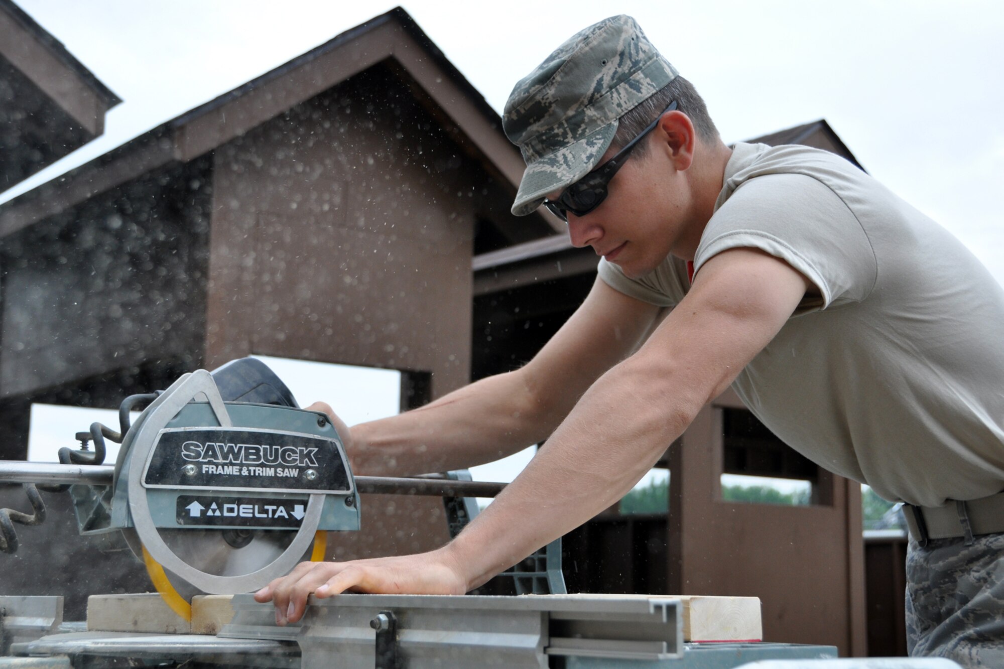 Senior Airman Trevor Reed, a heavy equipment operator assigned to the 307th Civil Engineer Squadron, cuts 2x4s during the construction of a Prime Base Engineer Emergency Force (Prime BEEF) training area at Youngstown Air Reserve Station, Vienna, Ohio, Aug. 14, 2012. Reed was part of a 29-person detail from Barksdale that spent two weeks at Youngstown ARS assisting 910th Civil Engineer Squadron personnel build the training area. (U.S. Air Force photo by Master Sgt. Jeff Walston)