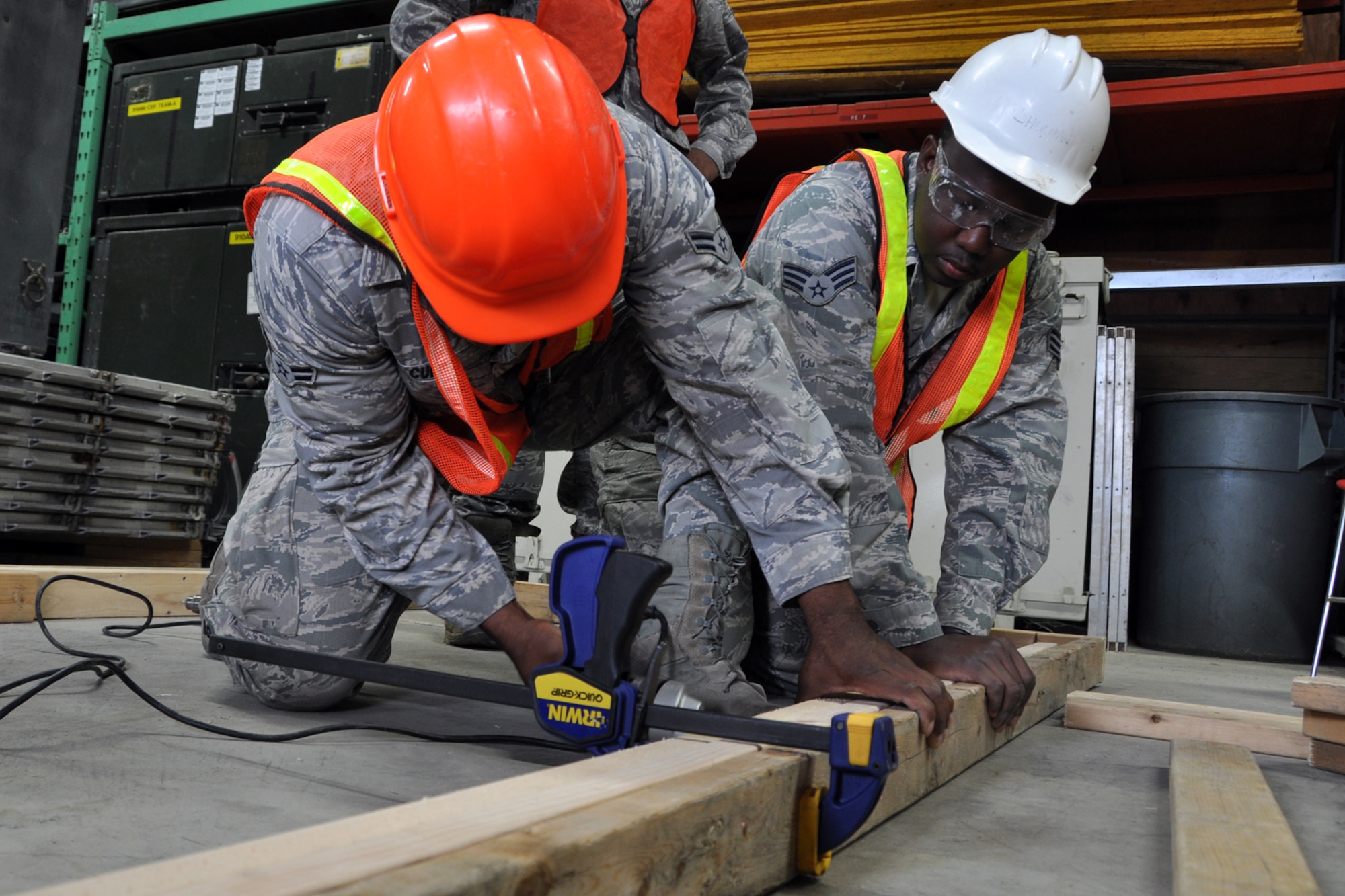 Senior Airman Thorton Allen holds a wood frame as Airman 1st Class Brandon Curry secures it with a screw at Youngstown Air Reserve Station, Vienna, Ohio, Aug. 14, 2012. The frame will be used in the construction of defensive fighting positions (DFP) at a Prime Base Engineer Emergency Force (Prime BEEF) training area. Allen is a heating, ventilation, air conditioning and refrigeration technician, and Curry is an electrician. Both Airmen are assigned to the 307th Civil Engineer Squadron from Barksdale Air Force Base, La. They were part of a 29-person detail from Barksdale that spent two weeks at Youngstown assisting the 910 Civil Engineer Squadron build a training area. (U.S. Air Force photo by Master Sgt. Jeff Walston) 