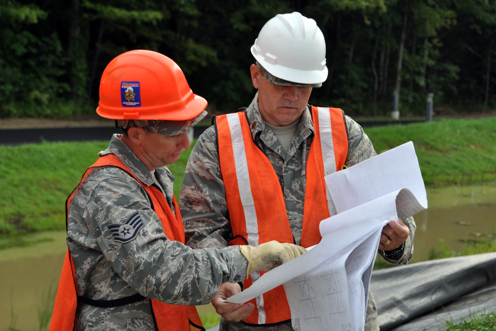 Staff Sgt Robert Ataway, a structures craftsman assigned to the 307th Civil Engineer Squadron from Barksdale Air Force Base, La., talks with Maj. Allen Spillers, chief of operations, 307 CES, about the next phase of construction of a Pre-Engineered Building at Youngstown Air Reserve Station, Vienna, Ohio, Aug. 14, 2012. They were part of a 29-person detail from Barksdale that spent two weeks at Youngstown ARS assisting 910th Civil Engineer Squadron personnel build a Prime Base Engineer Emergency Force (Prime BEEF) training area. (U.S. Air Force photo by Master Sgt. Jeff Walston)