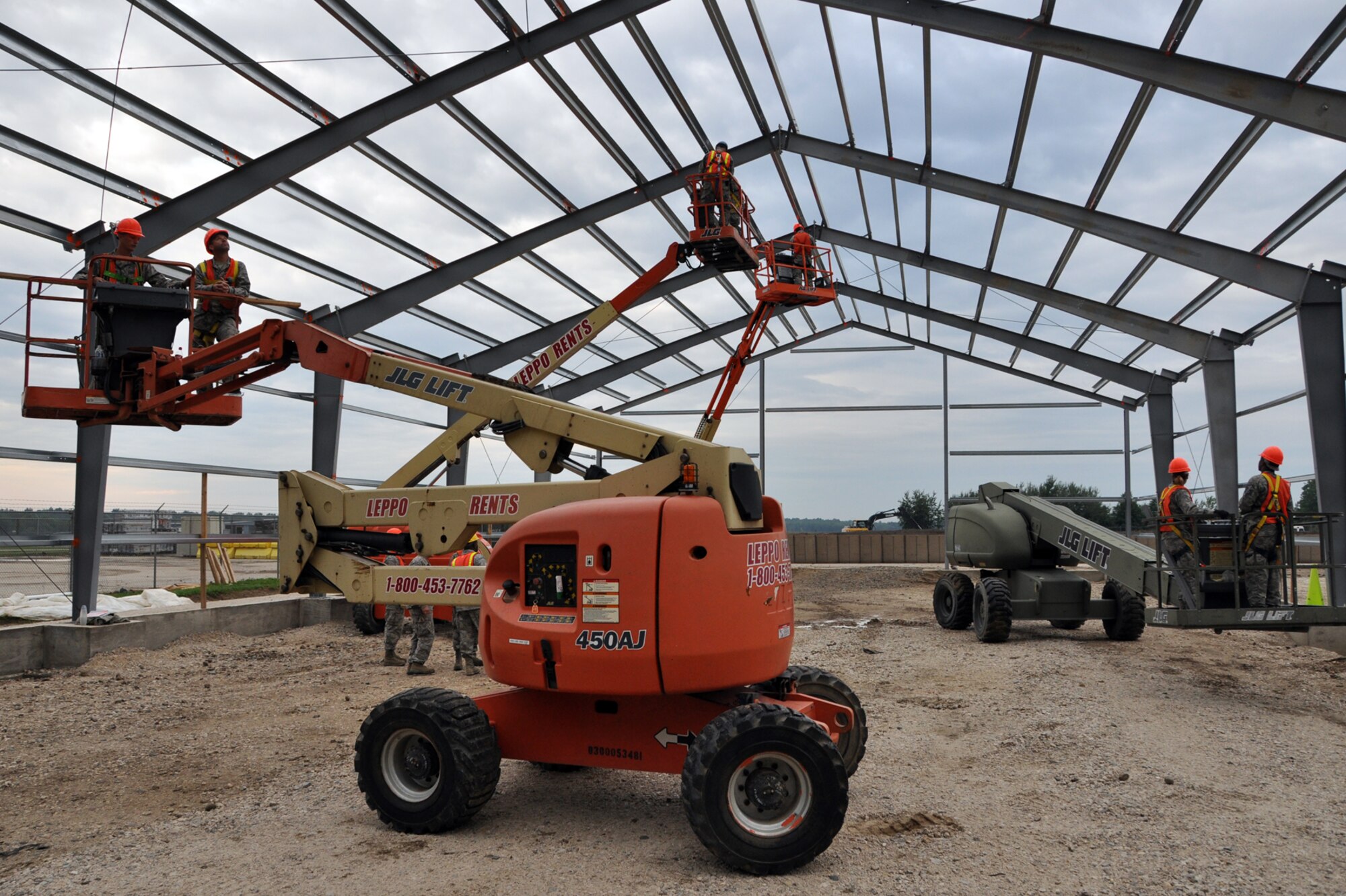 Members of the 307th Civil Engineer Squadron from Barksdale Air Force Base, La., join 910th Civil Engineer Squadron personnel in the construction of a Pre-Engineered building, at Youngstown Air Reserve Station, Vienna, Ohio, Aug. 14, 2012. A 29-person detail from Barksdale spent two weeks at Youngstown assisting the 910 CES build a Prime Base Engineer Emergency Force (Prime BEEF) training area. (U.S. Air Force photo by Master Sgt. Jeff Walston) 
