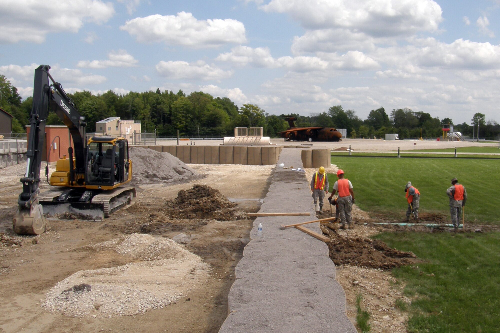 Members of the 307th Civil Engineer Squadron from Barksdale Air Force Base, La., join 910th Civil Engineer Squadron personnel to construct a drainage system for a Prime Base Engineer Emergency Force (Prime BEEF) training area at Youngstown Air Reserve Station, Vienna, Ohio, Aug. 13, 2012. A 29-person detail from Barksdale spent two weeks at Youngstown assisting the 910 CES with construction projects at the training area. (U.S. Air Force photo by Chief Master Sgt. Randall Noble)