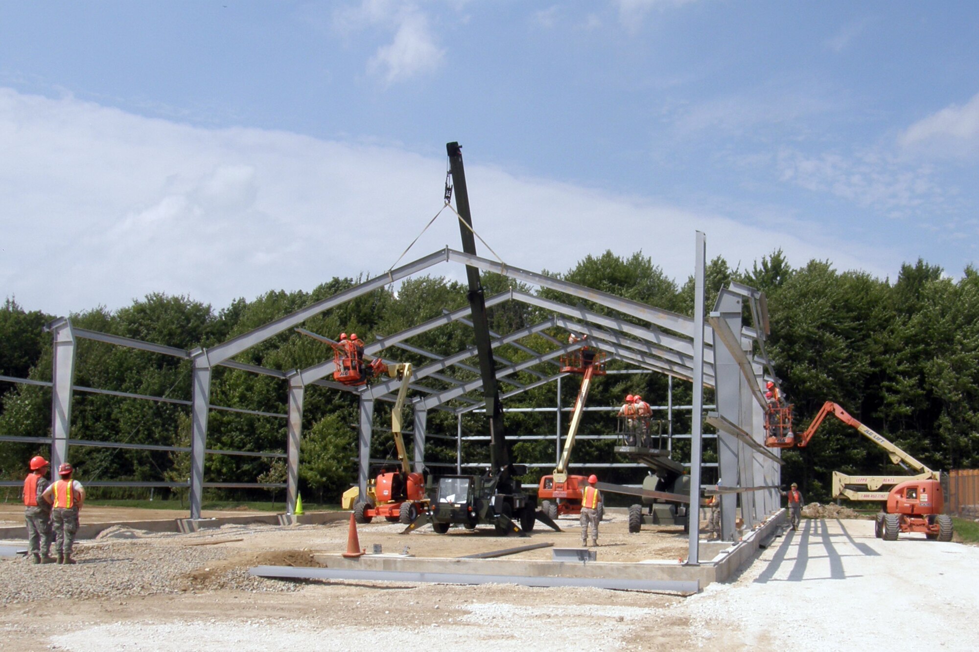 Members of the 307th Civil Engineer Squadron from Barksdale Air Force Base, La., join 910th Civil Engineer Squadron personnel in the construction of a Pre-Engineered building, at Youngstown Air Reserve Station, Vienna, Ohio, Aug. 9, 2012. A 29-person detail from Barksdale spent two weeks at Youngstown assisting the 910 CES build a Prime Base Engineer Emergency Force (Prime BEEF) training area. (U.S. Air Force photo by Chief Master Sgt. Randall Noble)