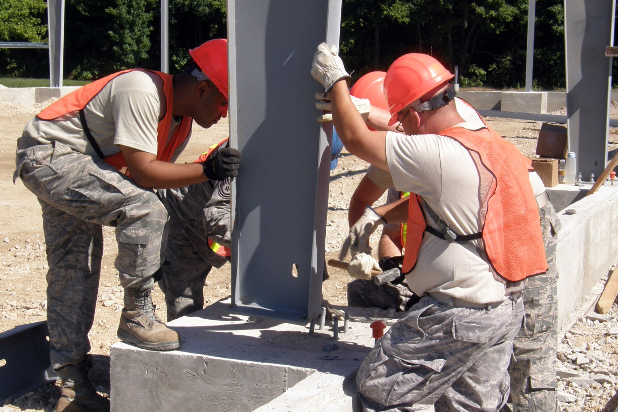 Members of the 307th Civil Engineer Squadron from Barksdale Air Force Base, La., join 910th Civil Engineer Squadron personnel in the construction of a Pre-Engineered building, at Youngstown Air Reserve Station, Vienna, Ohio, Aug. 6, 2012. A 29-person detail from Barksdale spent two weeks at Youngstown assisting the 910 CES build a Prime Base Engineer Emergency Force (Prime BEEF) training area. (U.S. Air Force photo by Chief Master Sgt. Randall Noble)