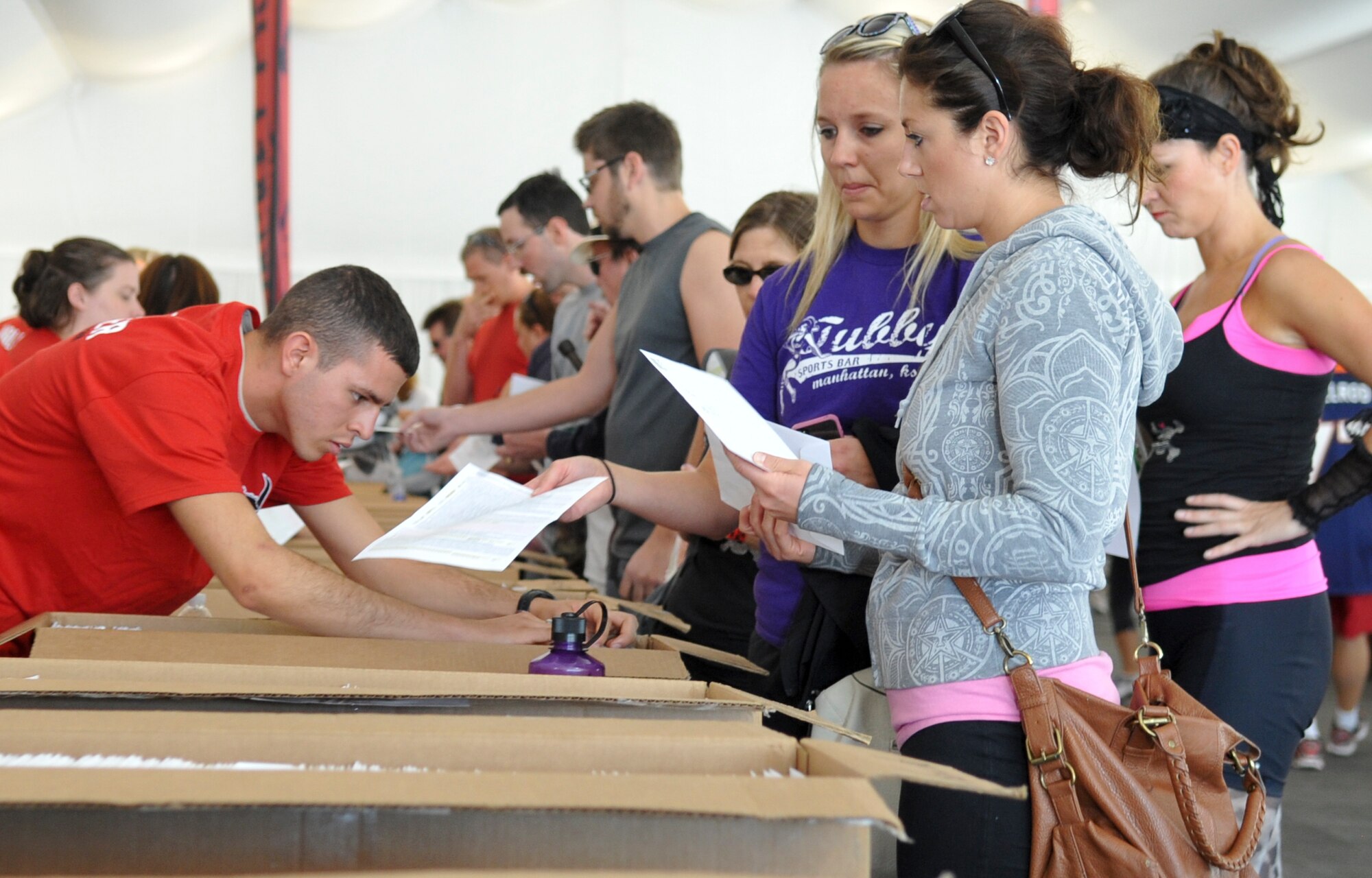 COPPER MOUNTAIN, Colo. – Team Buckley volunteers pull packets for runners as they check into Warrior Dash Aug. 18, 2012. The extreme 5K race consisted of 12 obstacles and event proceeds went toward supporting St. Jude Children’s Research Hospital. (U.S. Air Force photo by Senior Airman Christopher Gross)