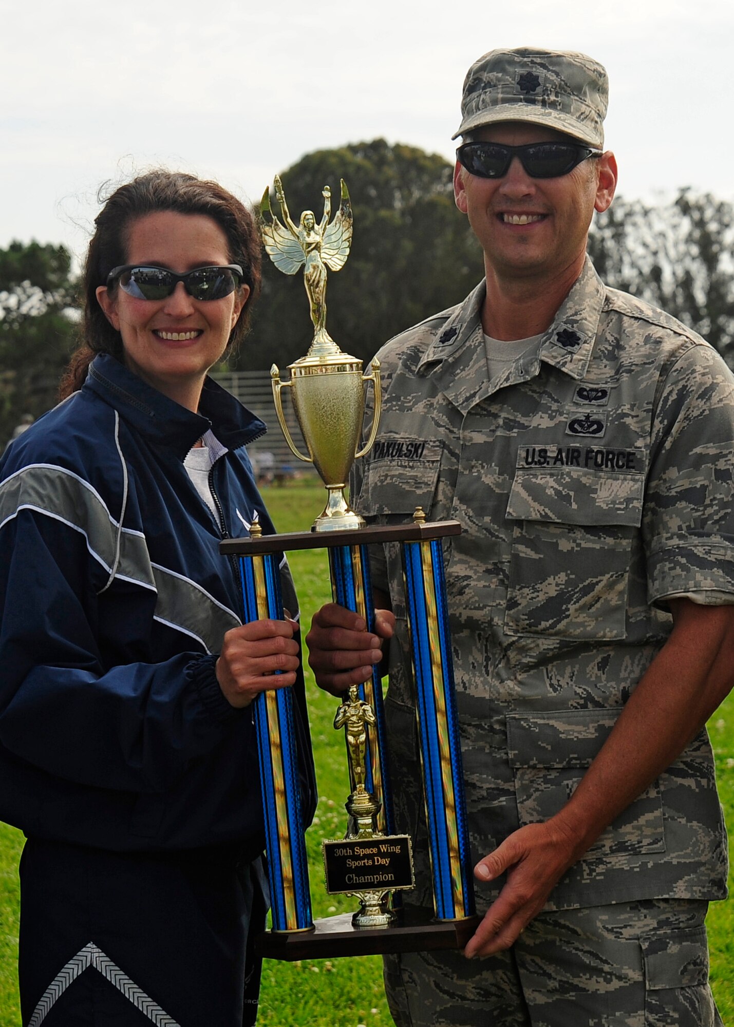 VANDENBERG AIR FORCE BASE, Calif. -- Col. Nina Armagno, 30th Space Wing Commander, awards Lt. Col. Dennis Pakulski, acting 30th Civil Engineer Squadron commander, with the first place trophy during the sports day closing ceremony here Friday, August 17, 2012. Sports day is organized by the 30th Force Support Squadron Fitness Center staff and offers squadrons and organizational teams a chance to compete in a variety of sporting events throughout the day. (U.S. Air Force photo/Michael Peterson)