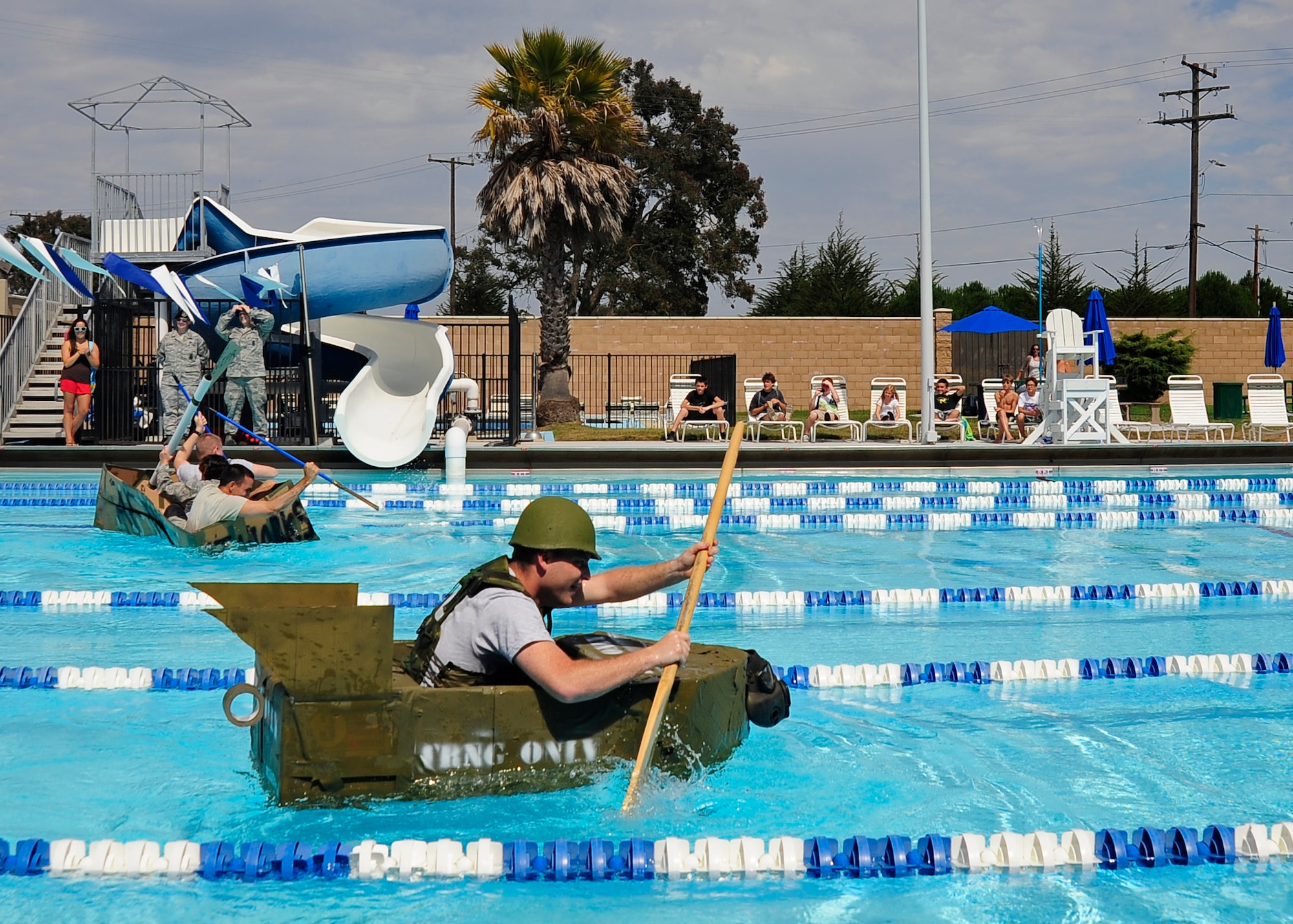 VANDENBERG AIR FORCE BASE, Calif. -- Airman 1st Class Tyler Little, a 30th Civil Engineer Squadron readiness and emergency management apprentice, rows his way to an early lead and the win during the cardboard regatta event for sports day here Friday, August 17, 2012. Sports day is organized by the 30th Force Support Squadron Fitness Center staff and offers squadrons and organizational teams a chance to compete in a variety of sporting events throughout the day. The 30th Civil Engineer Squadron finished the competition with the first place championship. (U.S. Air Force photo/Michael Peterson)