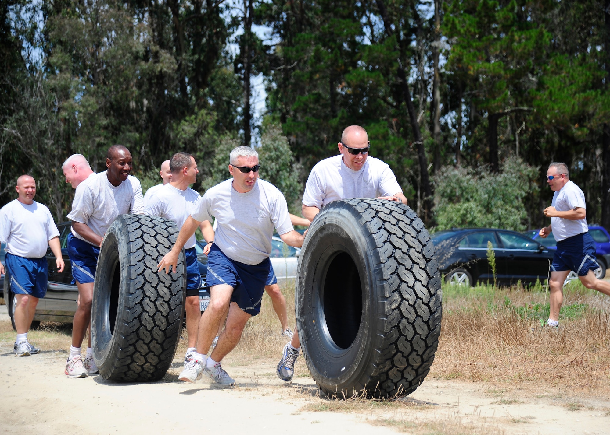 VANDENBERG AIR FORCE BASE, Calif. -- Teams for the Chiefs vs. Eagles relay challenge transition to the tire push portion of the race during sports day at Cocheo Park here Friday, August 17, 2012. Sports day is organized by the 30th Force Support Squadron Fitness Center staff and offers squadrons and organizational teams a chance to compete in a variety of sporting events throughout the day. The 30th Civil Engineer Squadron finished the competition with the first place championship. (U.S. Air Force photo/Michael Peterson)