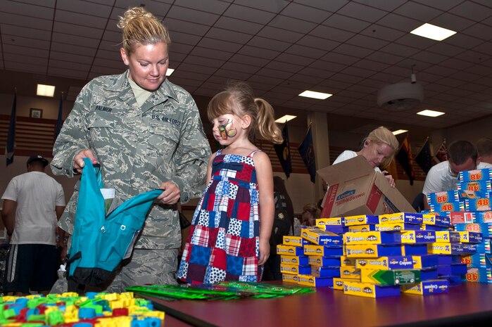 Tech. Sgt. Rebecca Palmer, 152nd Airlift Wing public affairs specialist, Nevada Air National Guard, gathers school supplies with her daughter, Alanah Palmer, 3, during the Operation Homefront's Backpacks for Back to School event Aug. 11, 2012, in Las Vegas, Nev. 1,300 backpacks were handed out state wide during the event. (U.S. Air Force photo by Staff Sgt. Christopher Hubenthal)