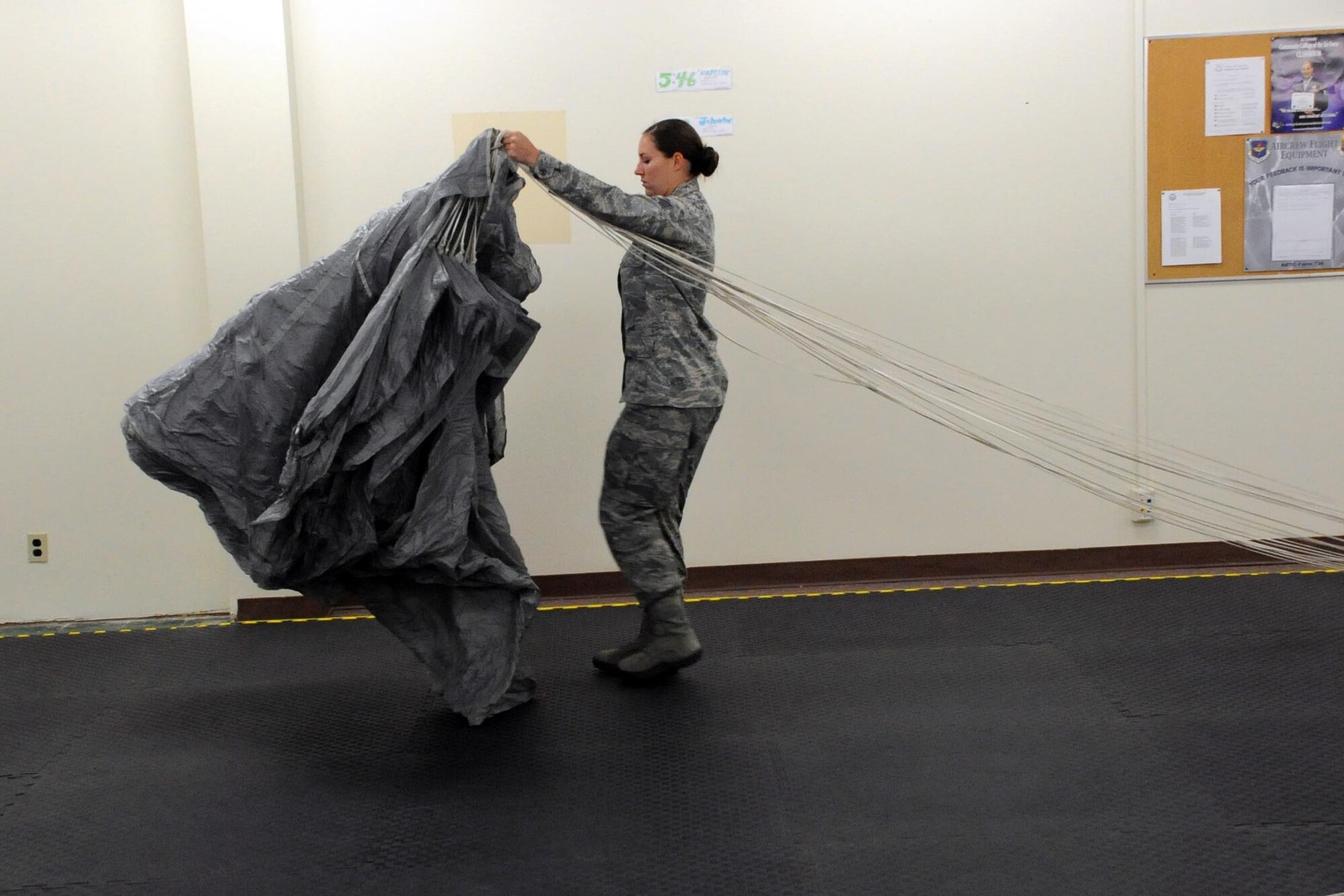 Staff Sgt. Amber Engelhart, Special Tactics Training Squadron aircrew flight equipment rigger at Hurlburt Field, Fla., inspects theMC-4 parachute system during RAM-AIR training Aug. 18, 2012 at Sheppard Air Force Base, Texas. Engelhart is receiving advanced parachute packing training for supervisors from the 361st Training Squadron.  (U.S. Air Force photo/Josh Wilson)
