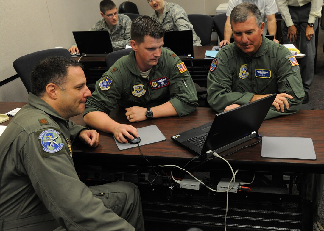 Brig. Gen. Jon Fago, Air Mobility Command Director of Operations, (right) goes over mobility plans with Maj. Bif French of the U.S. Air Force Expeditionary Center’s Mobility Operations School and Maj. Keith Johnson, 514th Air Mobility Operations Squadron during Global Mobility War Game 2012 at Joint Base McGuire-Dix-Lakehurst, N.J. Aug. 2.  (U.S. Air Force photo by Tech. Sgt. Zachary Wilson/Released)