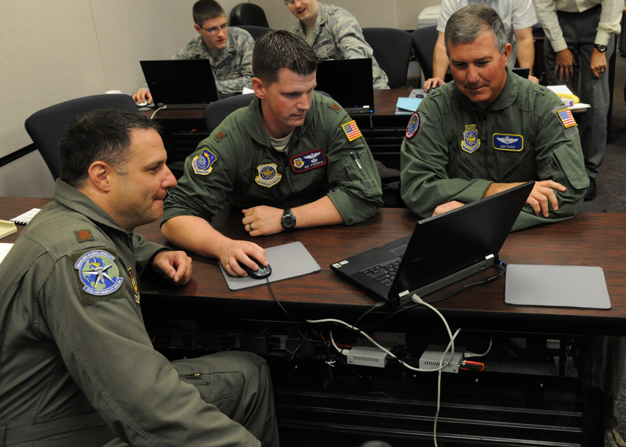 Brig. Gen. Jon Fago, Air Mobility Command Director of Operations, (right) goes over mobility plans with Maj. Bif French of the U.S. Air Force Expeditionary Center’s Mobility Operations School and Maj. Keith Johnson, 514th Air Mobility Operations Squadron during Global Mobility War Game 2012 at Joint Base McGuire-Dix-Lakehurst, N.J. Aug. 2.  (U.S. Air Force photo by Tech. Sgt. Zachary Wilson/Released)