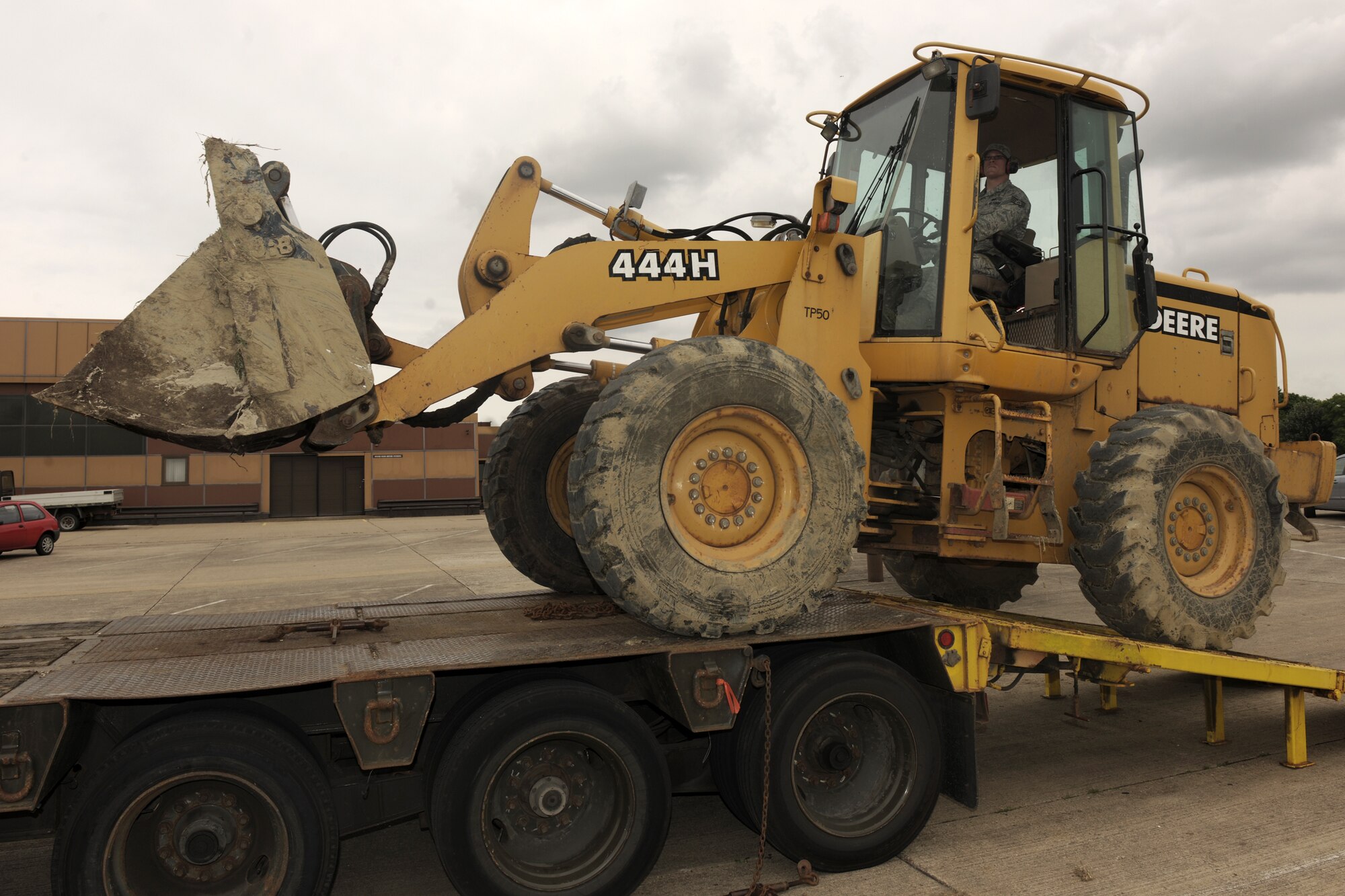 RAF ALCONBURY, United Kingdom - Staff Sgt. Adam Rouse, 423rd Civil Engineer Squadron, unloads a front-end loader from a tractor-trailer on RAF Alconbury Aug. 21. (U.S. Air Force photo by Master Sgt. John Barton)