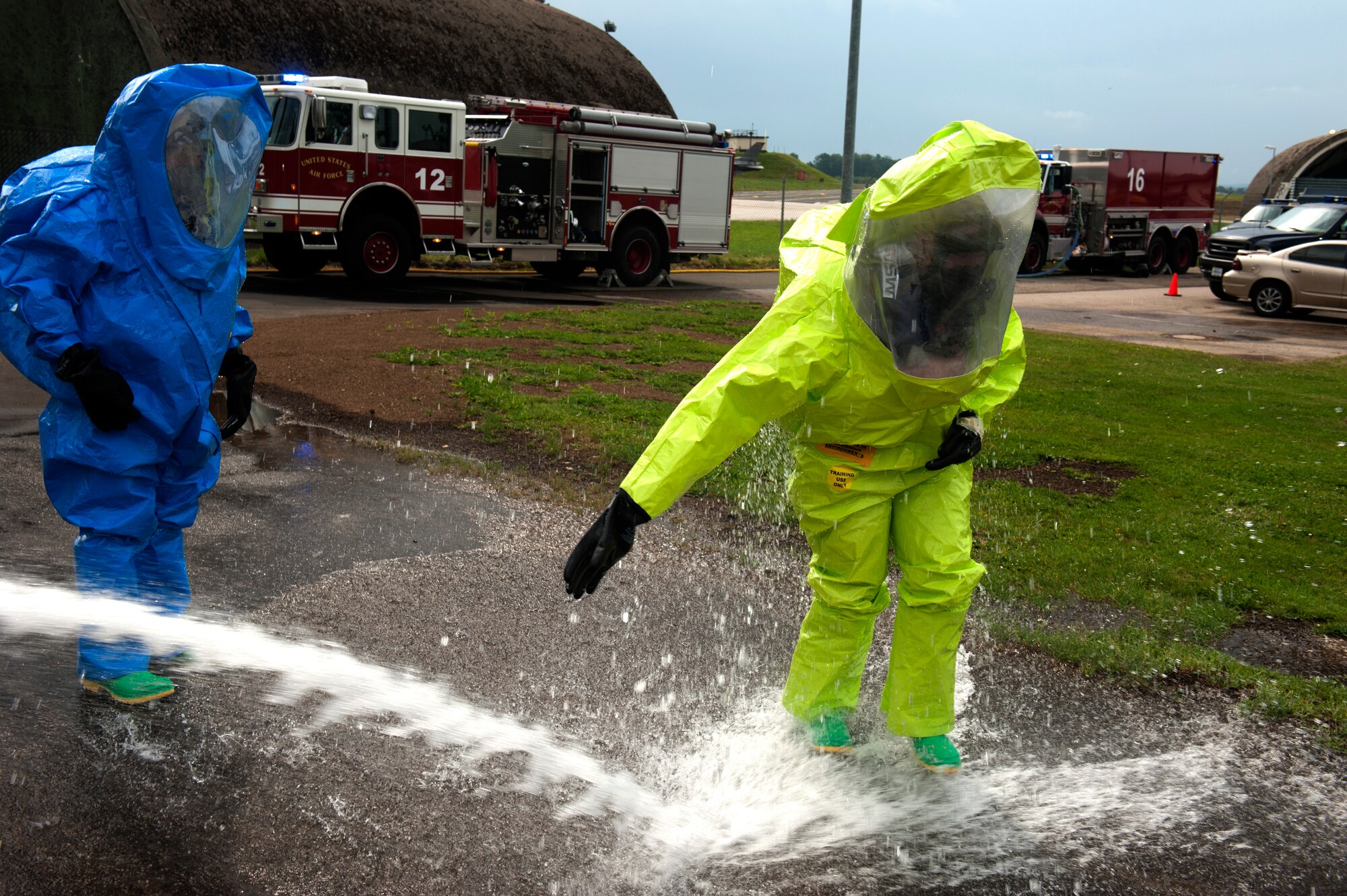 SPANGDAHLEM AIR BASE, Germany – Senior Airman Ashley Charfauros, 52nd Civil Engineer Squadron emergency management technician, walks through an emergency decontamination line after a simulated explosion during an exercise here Aug. 21.  Exercises like this test the technical skills and efficiency of first responders and emergency management procedures base-wide to strengthen the development of common tactics and techniques in preparation for real-world events. (U.S. Air Force photo by Airman 1st Class Gustavo Castillo/Released)