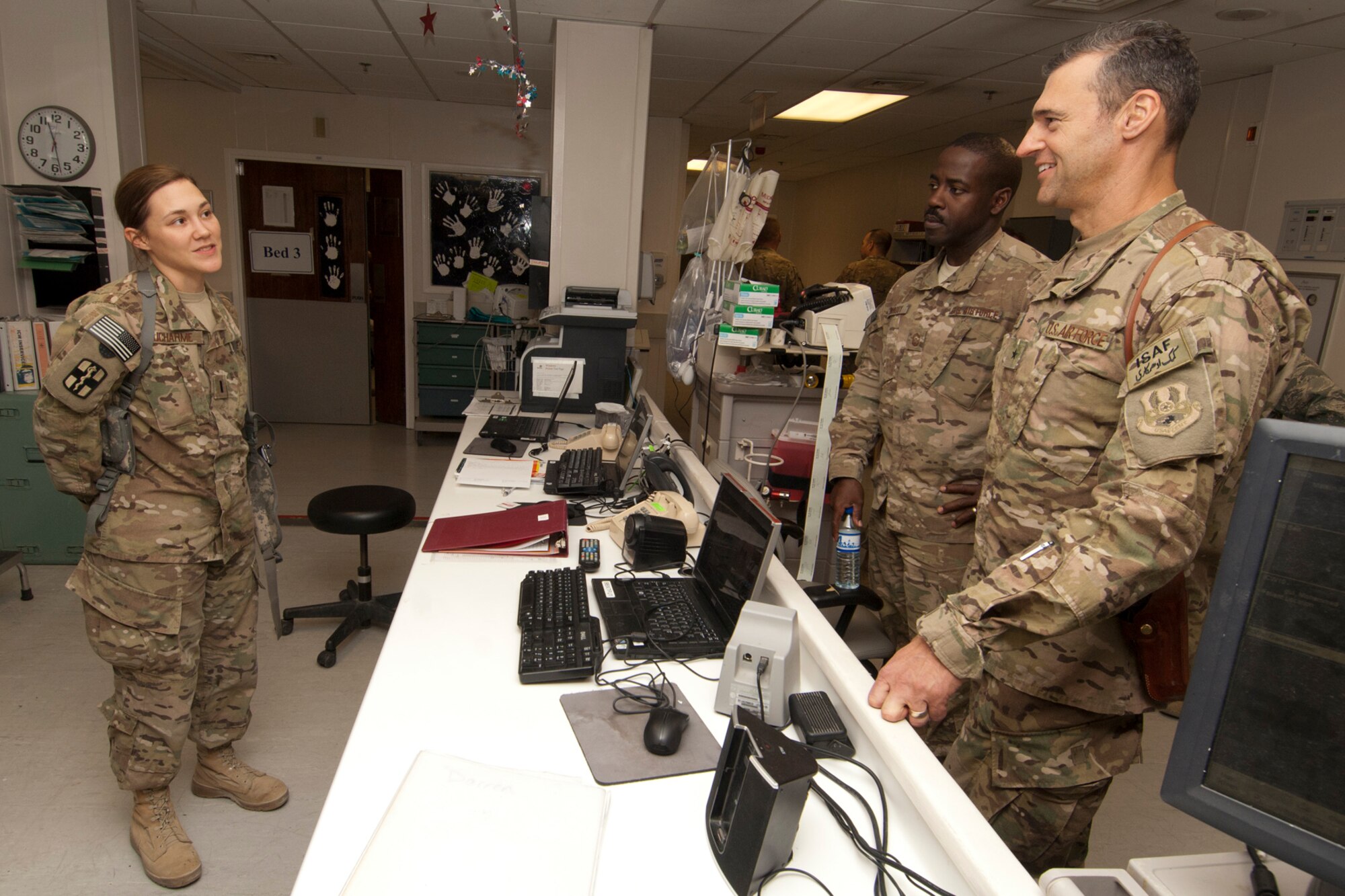 Brig. Gen. Joseph Guastella, 455th Air Expeditionary Wing commander, discusses local patient care procedures with 1st Lt. Nicole Ducharme, 455th Expeditionary medical Group Intermediate Care Ward nurse, during his visit to the Craig Joint Theater Hospital at Bagram Airfield, Afghanistan, Aug. 20, 2012. Ducharme told the commander that locals are usually grateful to American doctors and nurses at CJTH for allowing them to stay by the side of their loved ones in the Intermediate Care Ward. She said it facilitates a sense of humanity when locals see Americans caring for their loved ones. (U.S. Air Force photo/SSgt Jeff Nevison)