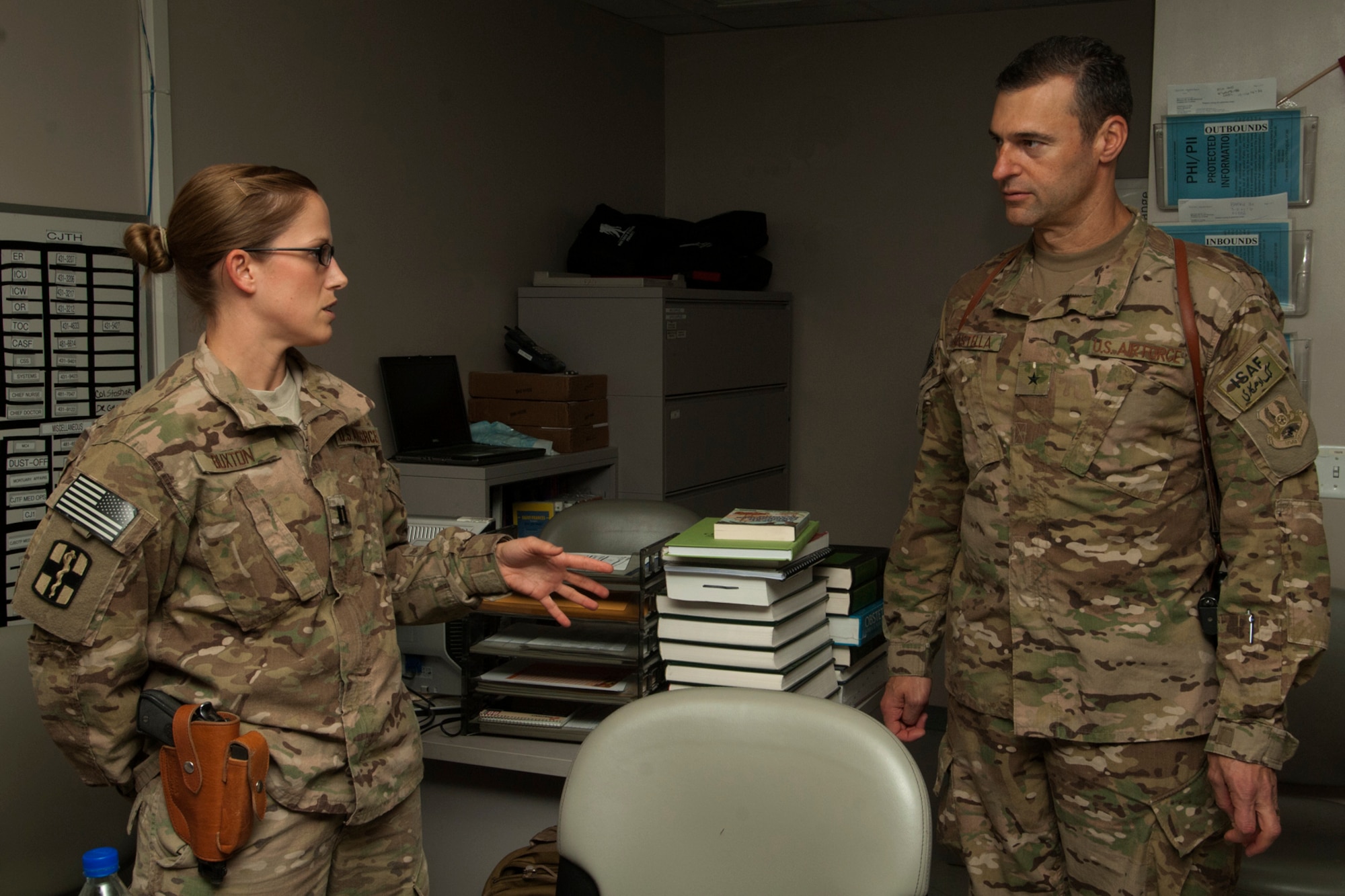 Brig. Gen. Joseph Guastella, 455th Air Expeditionary Wing commander, learns from Capt. Katrina Buxton, 455th Expeditionary Medical Group discharge planner, about patient discharge procedures during his visit to the Craig Joint Theater Hospital at Bagram Airfield, Afghanistan, Aug. 20, 2012. Guastella toured the hospital to meet staff members and learn about specialized services the hospital offers. Guastella expressed his appreciation to the members of CJTH for their hard work and dedication in treating injured U.S. servicemembers, locals and coalition forces. (U.S. Air Force photo/SSgt Jeff Nevison)