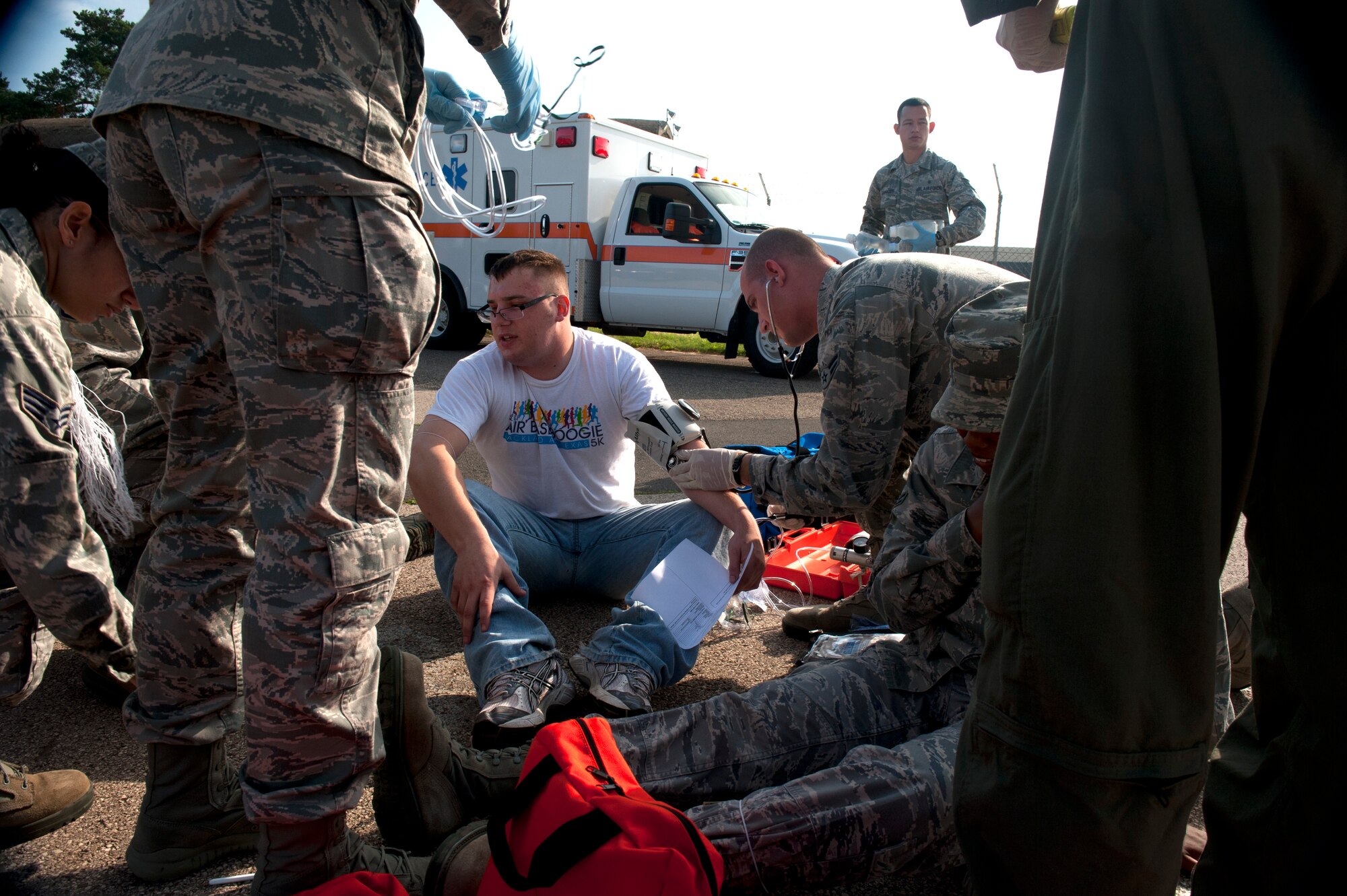 SPANGDAHLEM AIR BASE, Germany – Emergency first responders analyze the blood pressure of Airman 1st Class Zane Zimmerman, 52nd Logistics Readiness Squadron fuels distribution operator, after a simulated explosion during a base exercise here Aug. 21.  Exercises like this test the technical skills and efficiency of first responders and emergency management procedures base-wide to strengthen the development of common tactics and techniques in preparation for real-world events. (U.S. Air Force photo by Airman 1st Class Gustavo Castillo/Released)