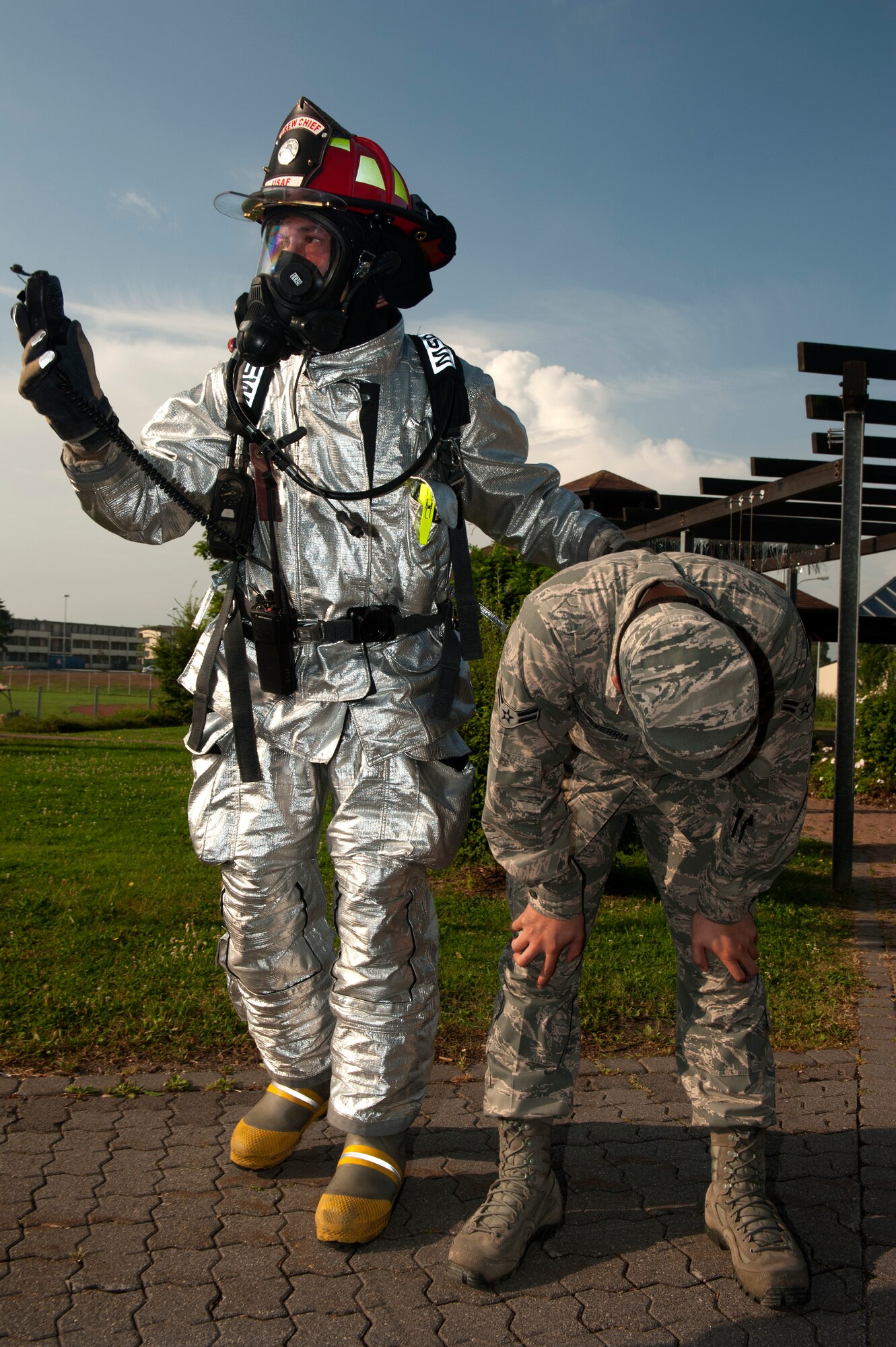 SPANGDAHLEM AIR BASE, Germany – Matthias Huewels, 52nd Civil Engineer Squadron fire fighter, tends to a victim after a simulated explosion during a base exercise here Aug. 21. Exercises like this test the technical skills and efficiency of first responders and emergency management procedures base-wide to strengthen the development of common tactics and techniques in preparation for real-world events. (U.S. Air Force photo by Airman 1st Class Gustavo Castillo/Released)
