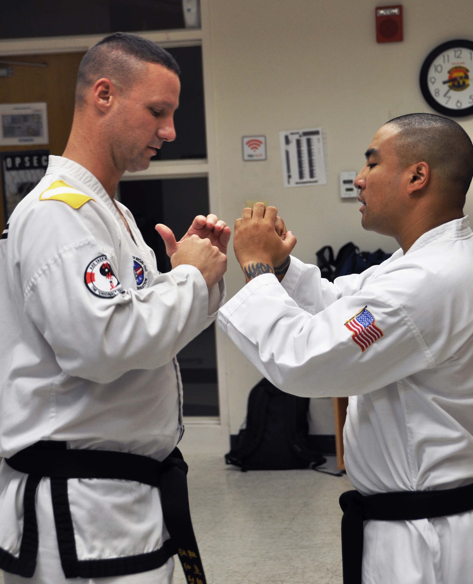 Lt. Col. Patrick Finan (left) goes over proper form with Tech. Sgt. John Villanueva during one of Finan’s free Teakwon-Do classes at the Osan Air Base, Republic of Korea Community Center. Classes are Tuesday’s and Thursdays from 7 p.m. to 9 p.m. for anyone who wants to participate. Finan is a 7th Air Force Inspector General and Armed Forces Director of the United States Taekwon-Do Federation. Villanueva is a 7th Air Force medical material apprentice. (U.S. Air Force photo/Staff Sgt. Stefanie Torres)