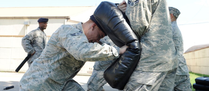 Airman 1st Class Patrick Donaldson, left, 8th Security Forces Squadron member, charges into a fellow defender during expandable baton training at Kunsan Air Base, Republic of Korea, Aug. 17, 2012. In addition to this charging technique, the members also learned how to properly use their baton against single and multiple attackers. (U.S. Air Force photo/Senior Airman Brigitte N. Brantley)