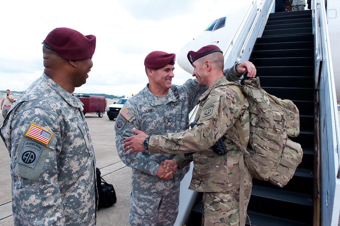 Army Brig. Gen. Charles Flynn, center, greets redeploying paratroopers at Pope Army Airfield on Fort Bragg, N.C., Aug. 2012. Flynn is commanding general of Task Force All American and also commanded the 82nd Airborne Division’s 1st Brigade Combat Team during a 2007 deployment to Iraq.