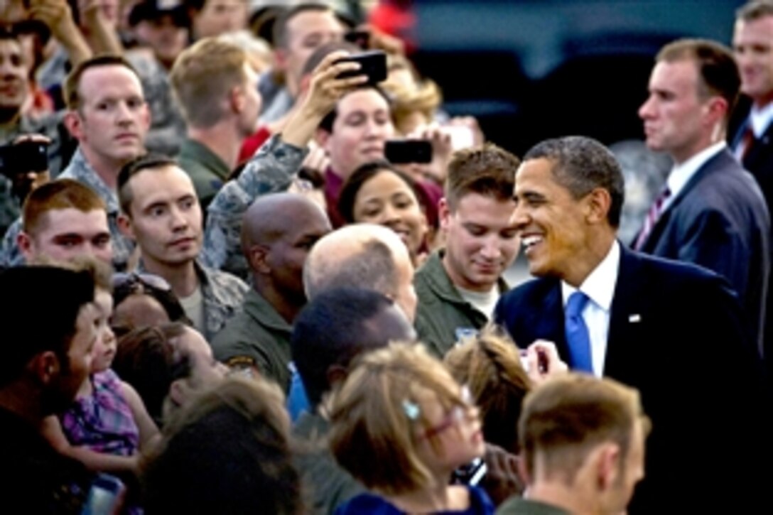 President Barack Obama greets airmen and family members during a visit to Nellis Air Force Base, Nev., Aug. 21, 2012. Obama was in Las Vegas to speak on education at Canyon Springs High School.