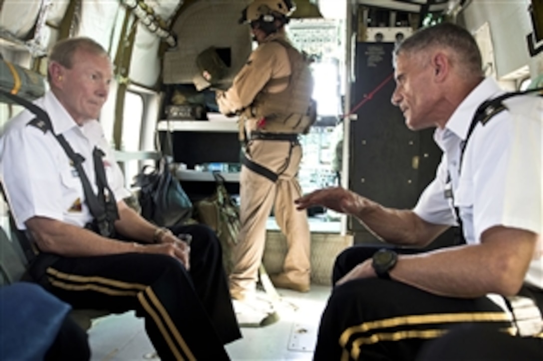 U.S. Army Lt. Gen. Robert Caslen, right, commander of the U.S. Office of Security Cooperation in Iraq, and U.S. Army Gen. Martin E. Dempsey, chairman of the Joint Chiefs of Staff, talk while flying over Baghdad, Aug. 21, 2012. 