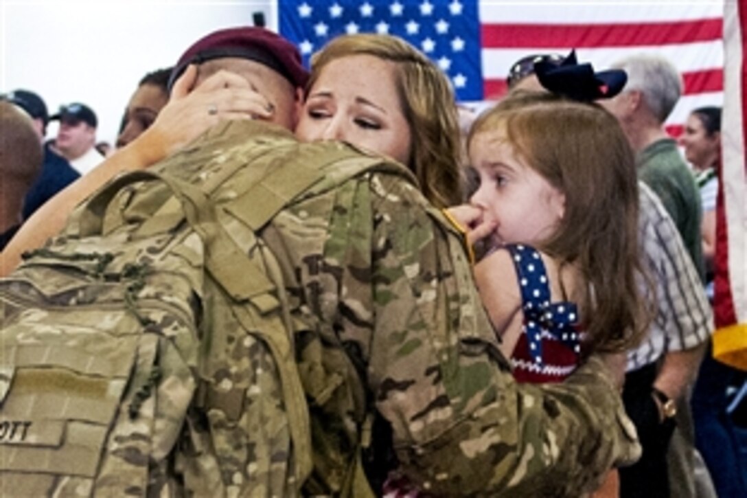 Caroline Scott embraces her husband, Army Sgt. Jerry Scott, during a homecoming ceremony at Pope Army Airfield on Fort Bragg, N.C., Aug. 20, 2012. Scott, a paratrooper, is assigned to the 82nd Airborne Division's 1st Brigade Combat Team.