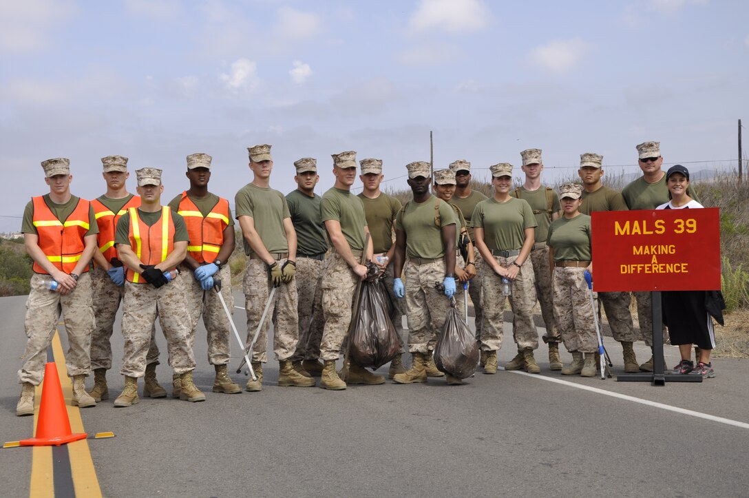 Marines from Marine Aviation Logistics Squadron 39 gather for a group photograph during a volunteer cultivation project near Camp Pendleton's Wire Mountain Housing area, Aug. 22.