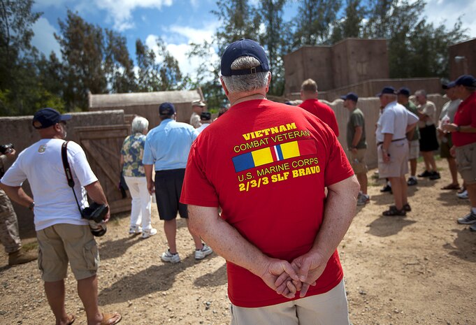 Former U.S. Marine Cpl. T.J. Croft (in red), a Vietnam veteran who served with Fox Company, 2nd Battalion, 3rd Marine Regiment, views a military operations on urban terrain (MOUT) training facility during a visit to Marine Corps Training Area Bellows, Hawaii, Aug. 22, 2012. Croft, a native of Omaha, Neb., served in Vietnam as a forward observer from 1966-1967. Nearly half a century since they fought through hell in Vietnam, approximately 30 former 2/3 Marines and their families visited the base to reminisce on their service and render honor to a brother lost in combat, Sgt. Maj. Wayne Hayes. Hayes was killed in action, Feb. 28, 1967, during Operation Prairie II while serving with many of the 2/3 veterans.
