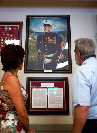 Deborah Bongiovi (left), the daughter of fallen U.S. Marine Sgt. Maj. Wayne Hayes, and a Vietnam veteran who served with Hayes in 2nd Battalion, 3rd Marine Regiment, view a portrait memorializing Hayes following a ceremony at the Rocker Room Staff Noncommissioned Officer Club on Marine Corps Base Hawaii, Aug. 22, 2012. Nearly half a century since they fought through hell in Vietnam, approximately 30 former 2/3 Marines and their families visited the base to reminisce on their service and render honor to Hayes. The Marine was killed in action, Feb. 28, 1967, during Operation Prairie II while serving with many of the 2/3 veterans.