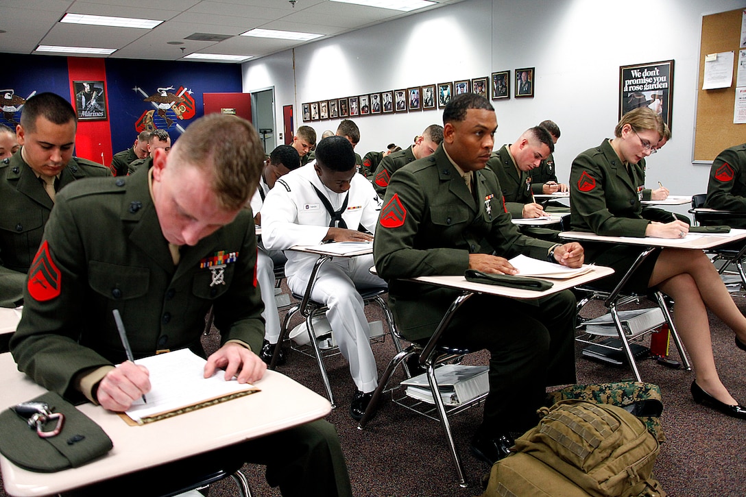 Marines with Cherry Point Corporals Leadership Course Class 274-12 fill out paperwork after checking into the course at the Training and Education Center, Aug. 13. The three-week course is the first Professional Military Education class enlisted Marines attend and focuses on leadership, history and tradition of Marine Corps corporals.
