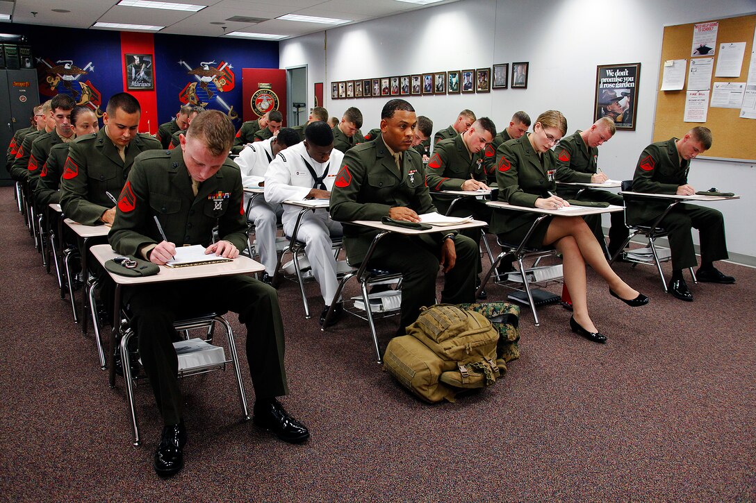 Marines with Cherry Point Corporals Leadership Course Class 274-12 fill out paperwork after checking into the course at the Training and Education Center, Aug. 13. The three-week course is the first Professional Military Education class enlisted Marines attend and focuses on leadership, history and tradition of Marine Corps corporals.