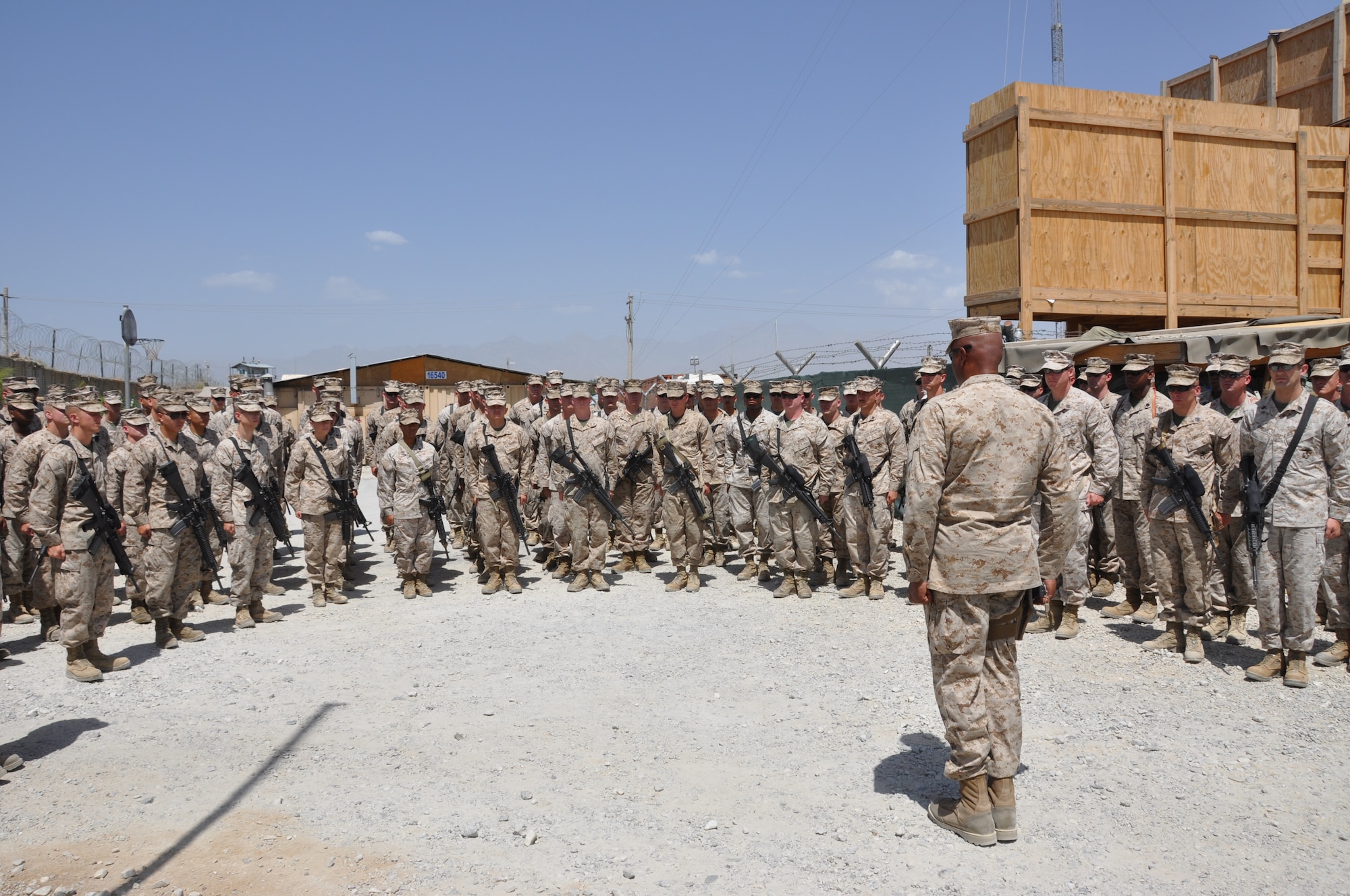 Sgt. Maj. Adam Moore, sergeant major of the Marine Tactical Electronic Warfare Squadron-2, issues the final "dismissed" to the Marine Tactical Electronic Warfare Squadron-2 to end Camp McCool's unit closing ceremony at Bagram Airfield, Afghanistan, Aug. 8, 2012. The ceremony reminded Camp McCool's final residents of its brief-but-important nine-year history. The camp was the site of an insurgent attack on Bagram in 2009. The camp was named in honor of U.S. Navy Commander William C. McCool, fellow EA-6B Prowler pilot, and pilot of the Space Shuttle Columbia's ill-fated STS-107, which broke up during its return to Earth in February 2003. (U.S. Air Force photo/TSgt Shawn McCowan)