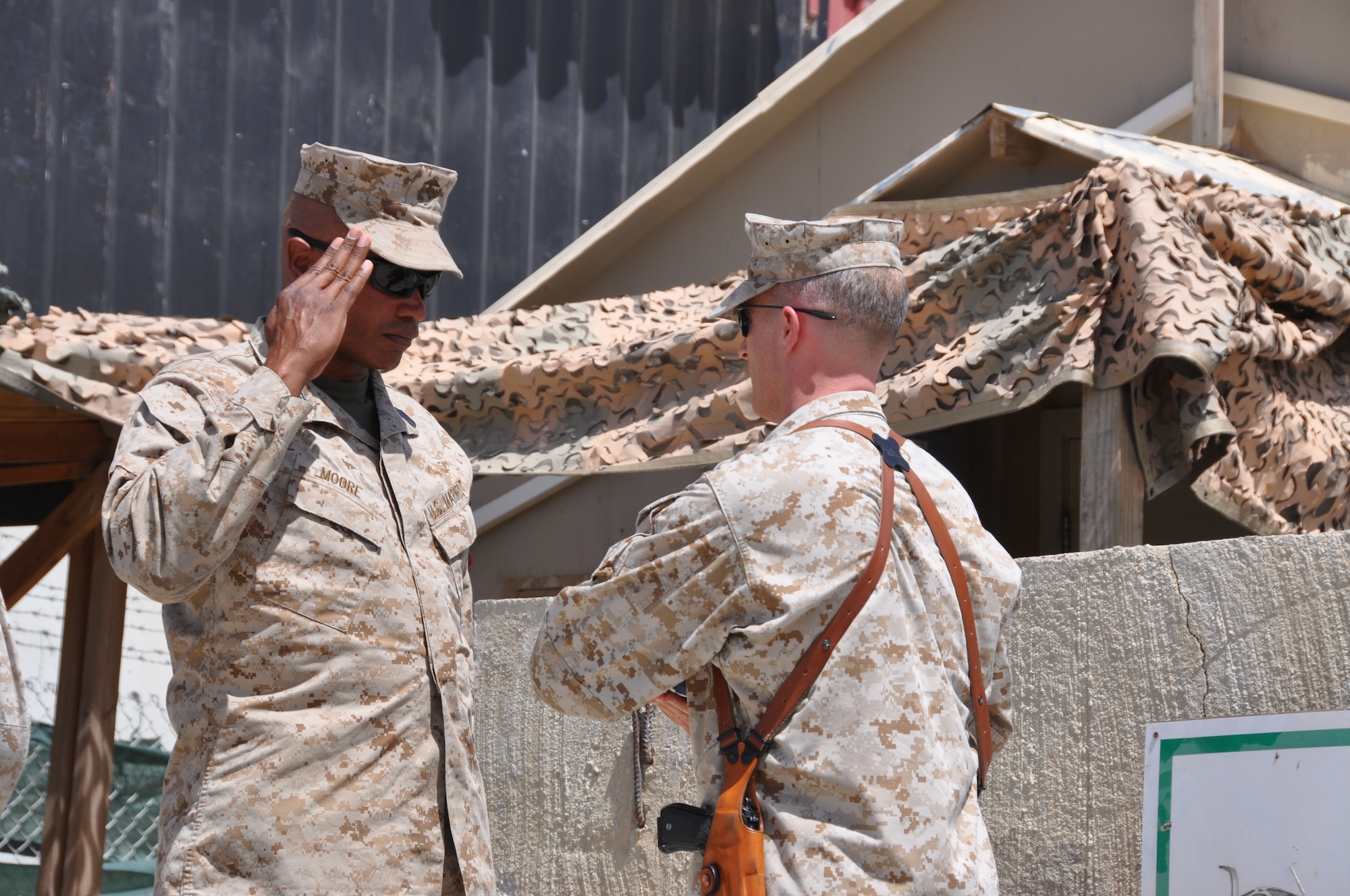 Lt. Col. Adam Musoff (right), unit commander, and Sgt. Maj. Adam Moore, sergeant major, of the Marine Tactical Electronic Warfare Squadron-2 honor their unit's American Flag at the end of Camp McCool's closing ceremony at Bagram Airfield, Afghanistan, Aug. 8, 2012. The ceremony reminded Camp McCool's final residents of its brief-but-important nine-year history. The camp was the site of an insurgent attack on Bagram in 2009. The camp was named in honor of U.S. Navy Commander William C. McCool, fellow EA-6B Prowler pilot, and pilot of the Space Shuttle Columbia's ill-fated STS-107, which broke up during its return to Earth in February 2003. (U.S. Air Force photo/TSgt Shawn McCowan)