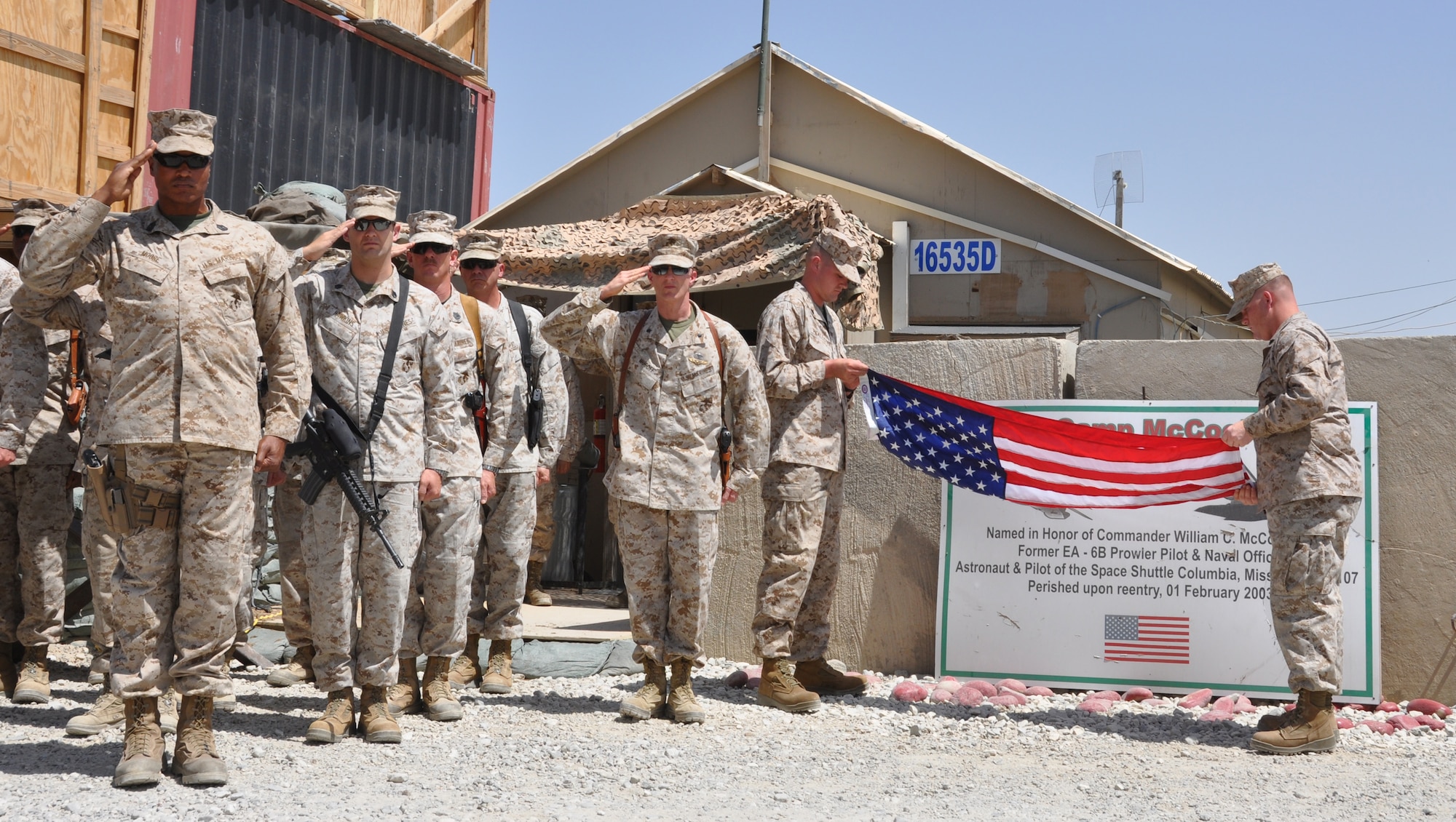 Members of the Marine Tactical Electronic Warfare Squadron-2 perform a flag-folding ceremony during "Camp McCool's" closing ceremony at Bagram Airfield, Afghanistan, Aug. 8, 2012. The ceremony reminded Camp McCool's final residents of its brief-but-important nine-year history. The camp was the site of an insurgent attack on Bagram in 2009. The camp was named in honor of U.S. Navy Commander William C. McCool, fellow EA-6B Prowler pilot, and pilot of the Space Shuttle Columbia's ill-fated STS-107, which broke up during its return to Earth in February 2003. (U.S. Air Force photo/TSgt Shawn McCowan)
