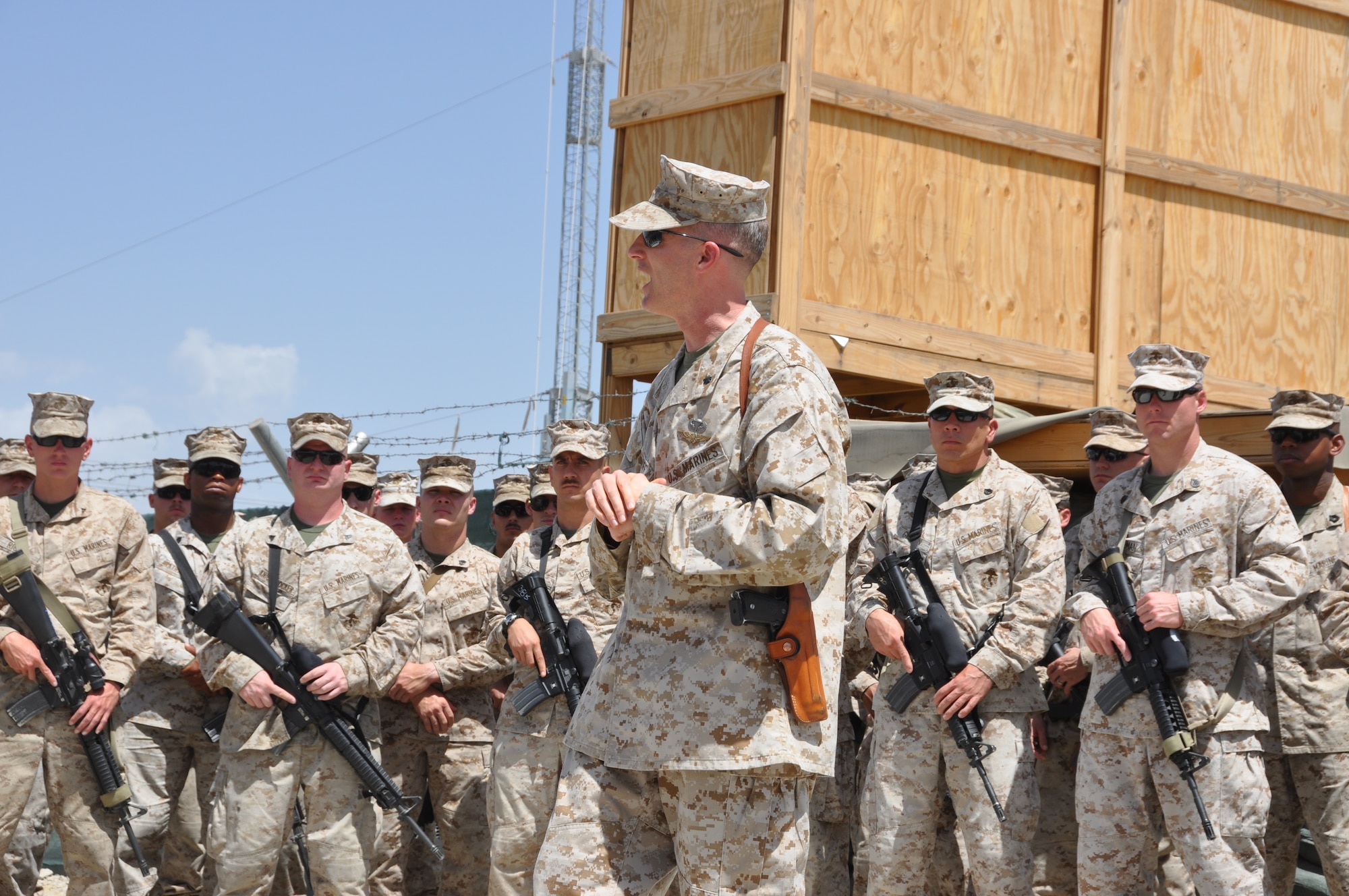 Lt. Col. Adam Musoff, commander of the Marine Tactical Electronic Warfare Squadron-2, reminds Camp McCool's final residents of its brief-but-important nine-year history during the camp's closing ceremony at Bagram Airfield, Afghanistan, Aug. 8, 2012. The camp was the site of an insurgent attack on Bagram in 2009. The camp was named in honor of U.S. Navy Commander William C. McCool, fellow EA-6B Prowler pilot, and pilot of the Space Shuttle Columbia's ill-fated STS-107, which broke up during its return to Earth in February 2003. (U.S. Air Force photo/TSgt Shawn McCowan)