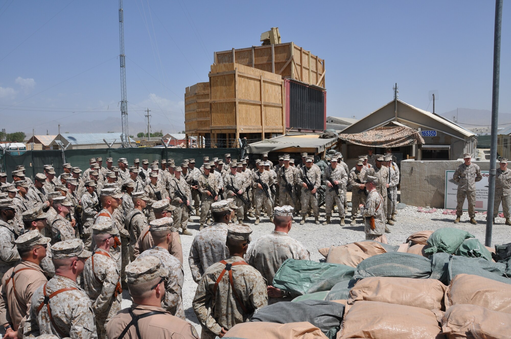 Lt. Col. Adam Musoff, commander of the Marine Tactical Electronic Warfare Squadron-2, reminds Camp McCool's final residents of its brief-but-important nine-year history during the camp's closing ceremony at Bagram Airfield, Afghanistan, Aug. 8, 2012. The camp was the site of an insurgent attack on Bagram in 2009. The camp was named in honor of U.S. Navy Commander William C. McCool, fellow EA-6B Prowler pilot, and pilot of the Space Shuttle Columbia's ill-fated STS-107, which broke up during its return to Earth in February 2003. (U.S. Air Force photo/TSgt Shawn McCowan)