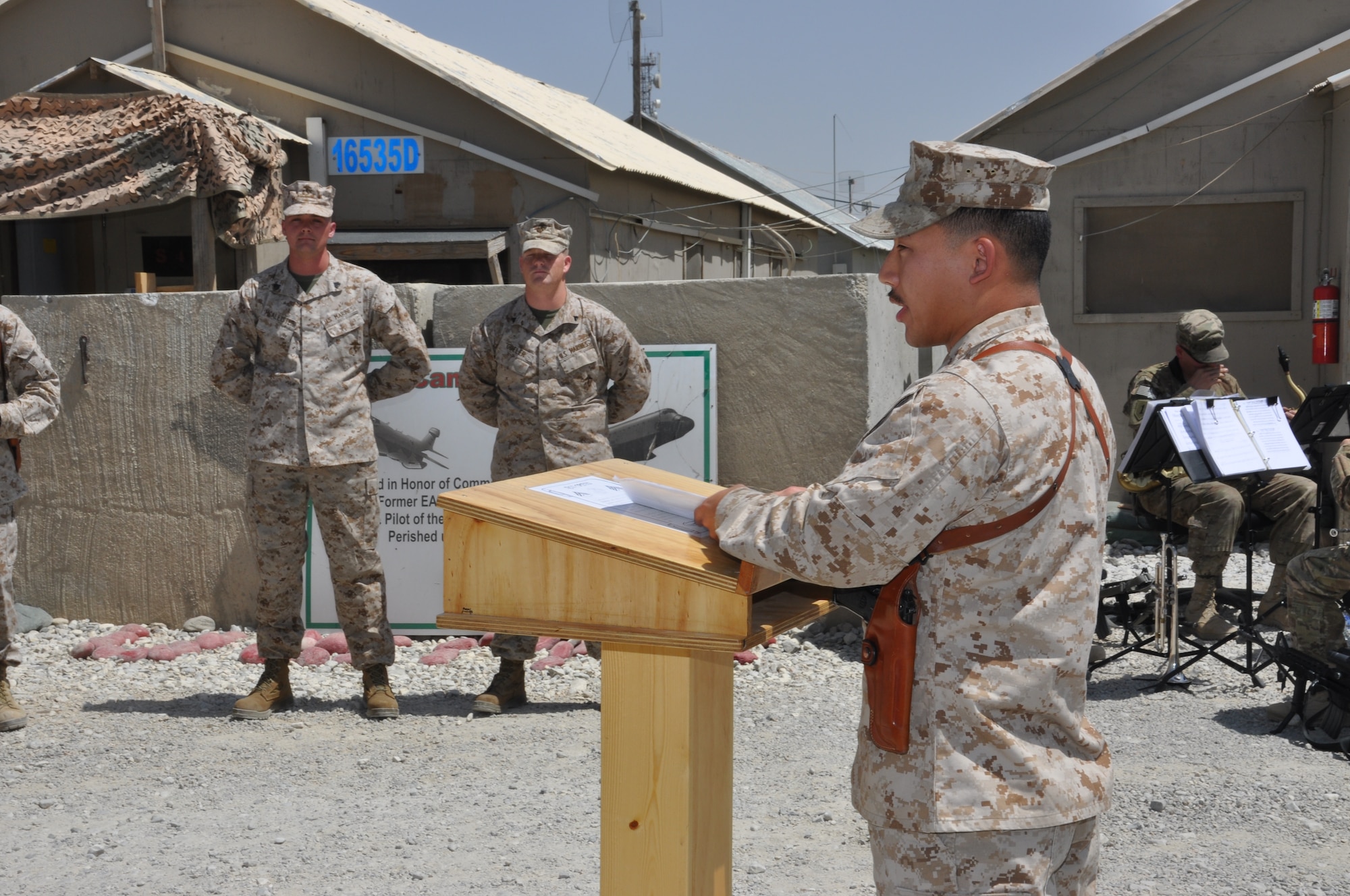 Capt. Jonathan Boersma, Marine Tactical Electronic Warfare Squadron-2 pilot, led a short and somber unit closing ceremony at Camp McCool on Bagram Airfield, Afghanistan, Aug. 8, 2012. The ceremony reminded the camp's final residents of its brief-but-important nine-year history. The camp was the site of an insurgent attack on Bagram in 2009. The camp was named in honor of U.S. Navy Commander William C. McCool, fellow EA-6B Prowler pilot, and pilot of the Space Shuttle Columbia's ill-fated STS-107, which broke up during its return to Earth in February 2003. (U.S. Air Force photo/TSgt Shawn McCowan)
